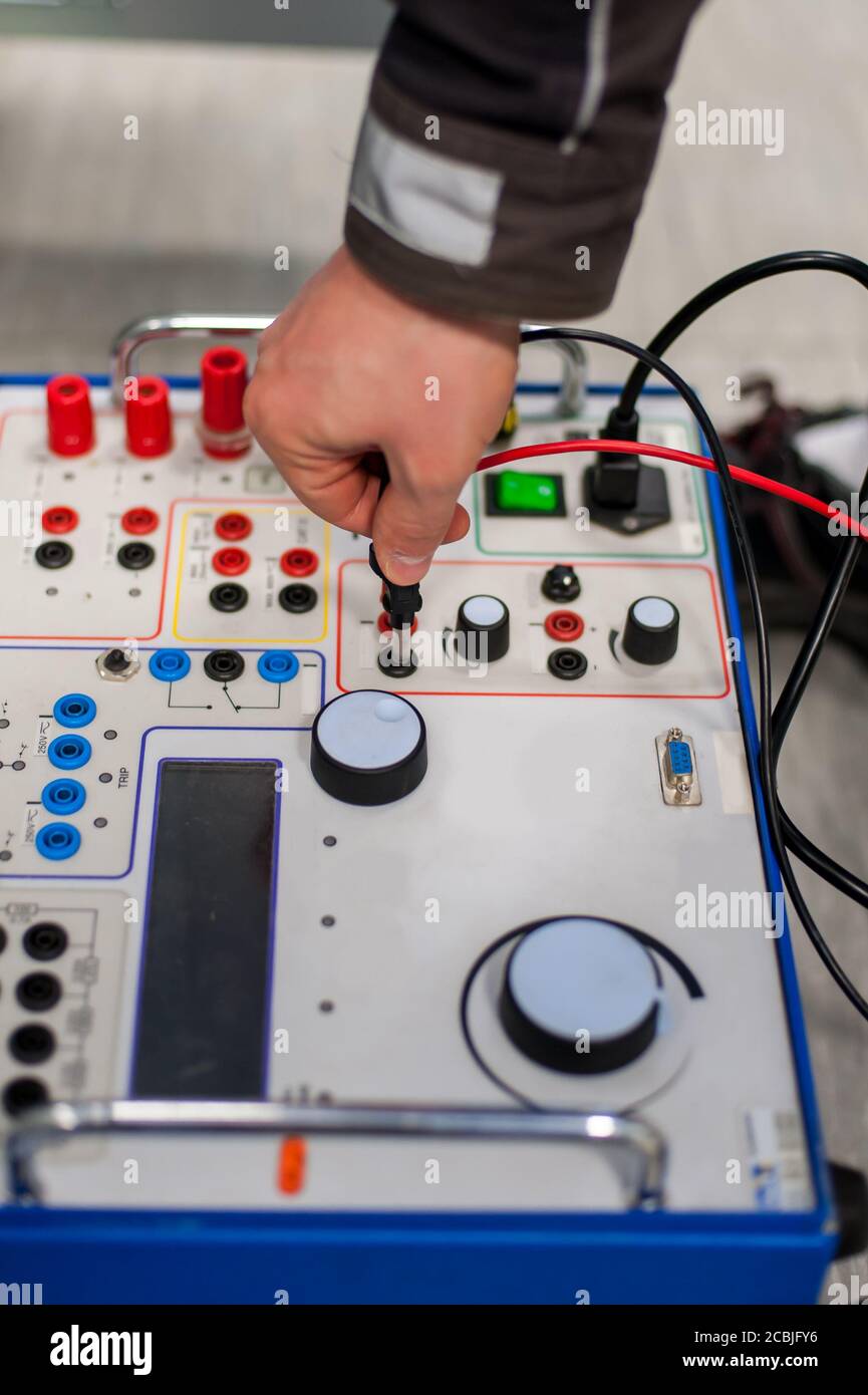 Maintenance engineer inspect system with relay test set equipment