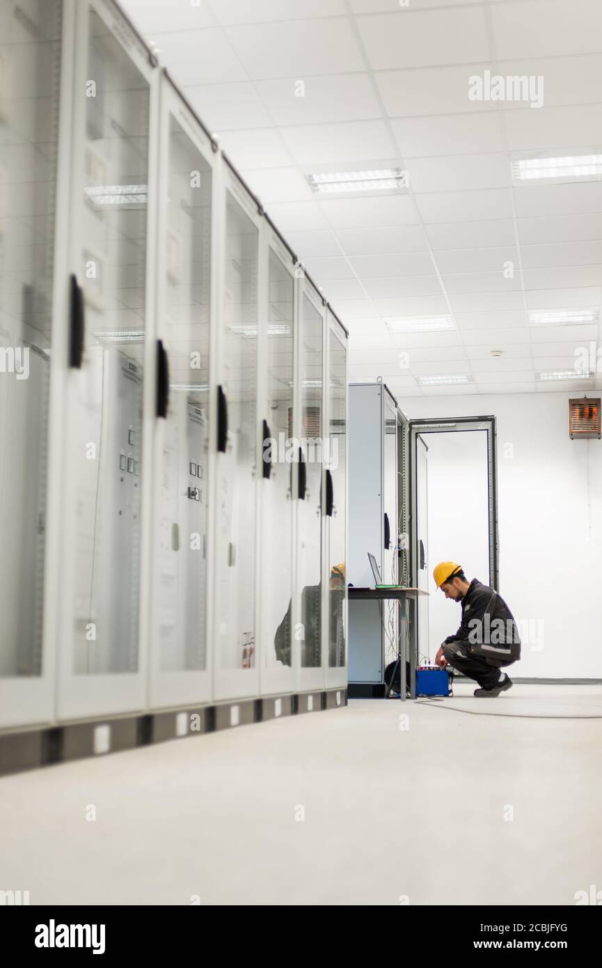 Maintenance engineer inspect system with relay test set equipment