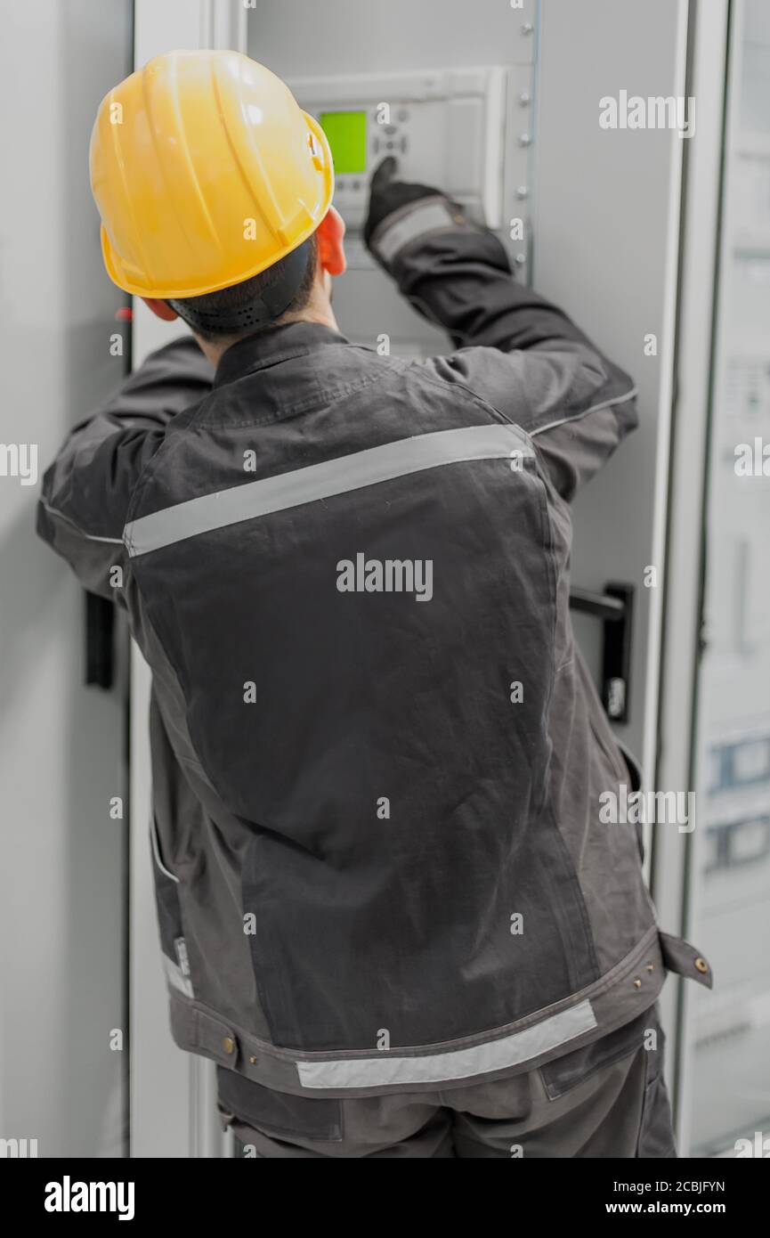 Maintenance engineer testing medium voltage switchgear and bay control