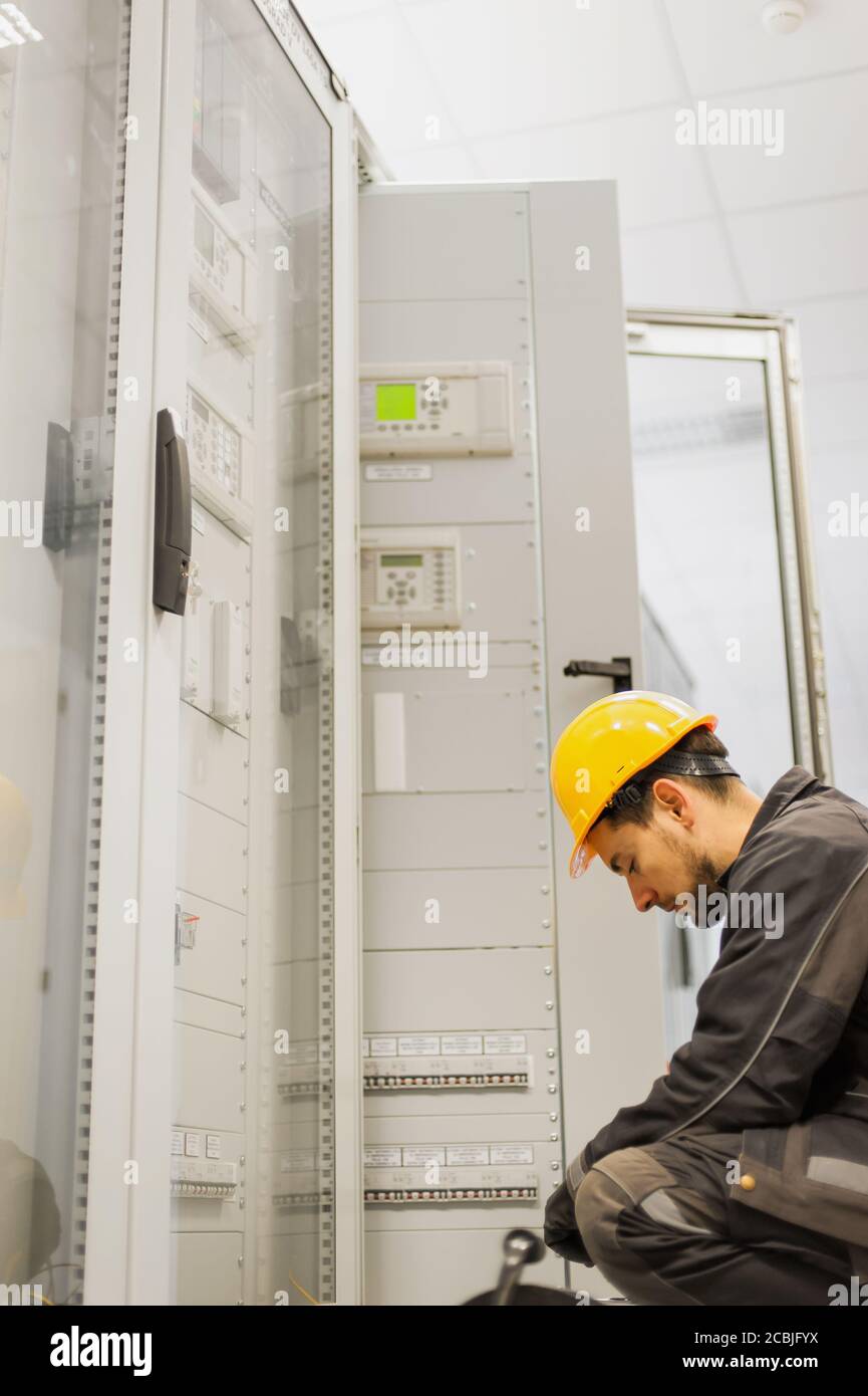 Maintenance engineer testing medium voltage switchgear and bay control
