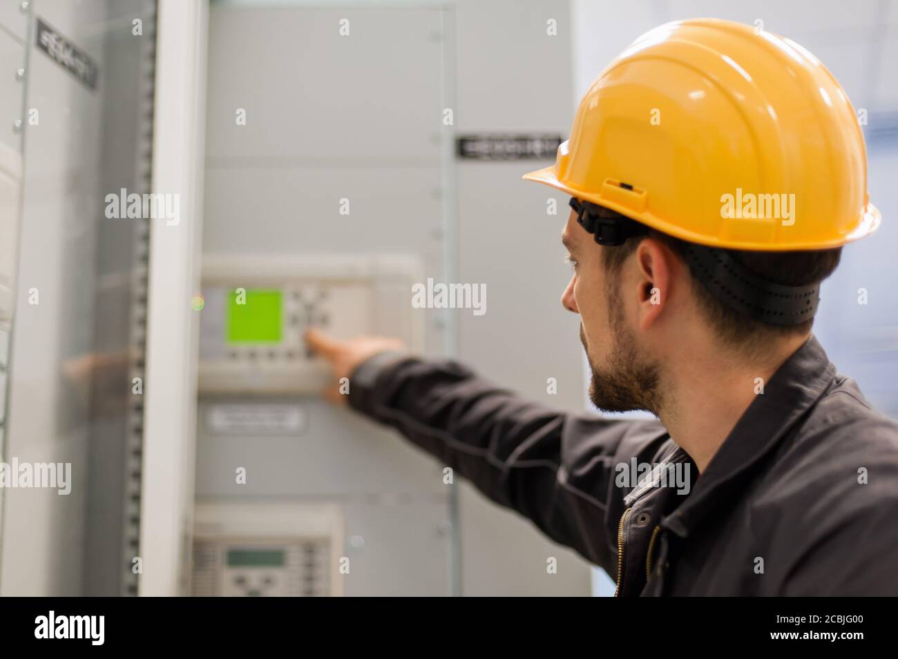 Maintenance engineer testing medium voltage switchgear and bay control