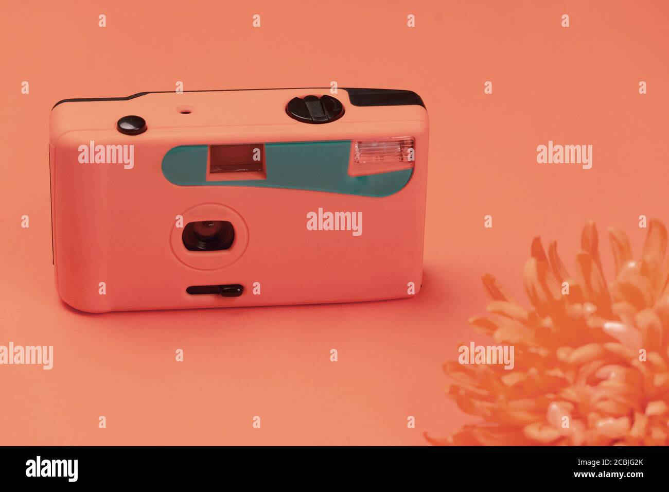 pastel orange pink blue plastic camera with blur flower vintage background Stock Photo