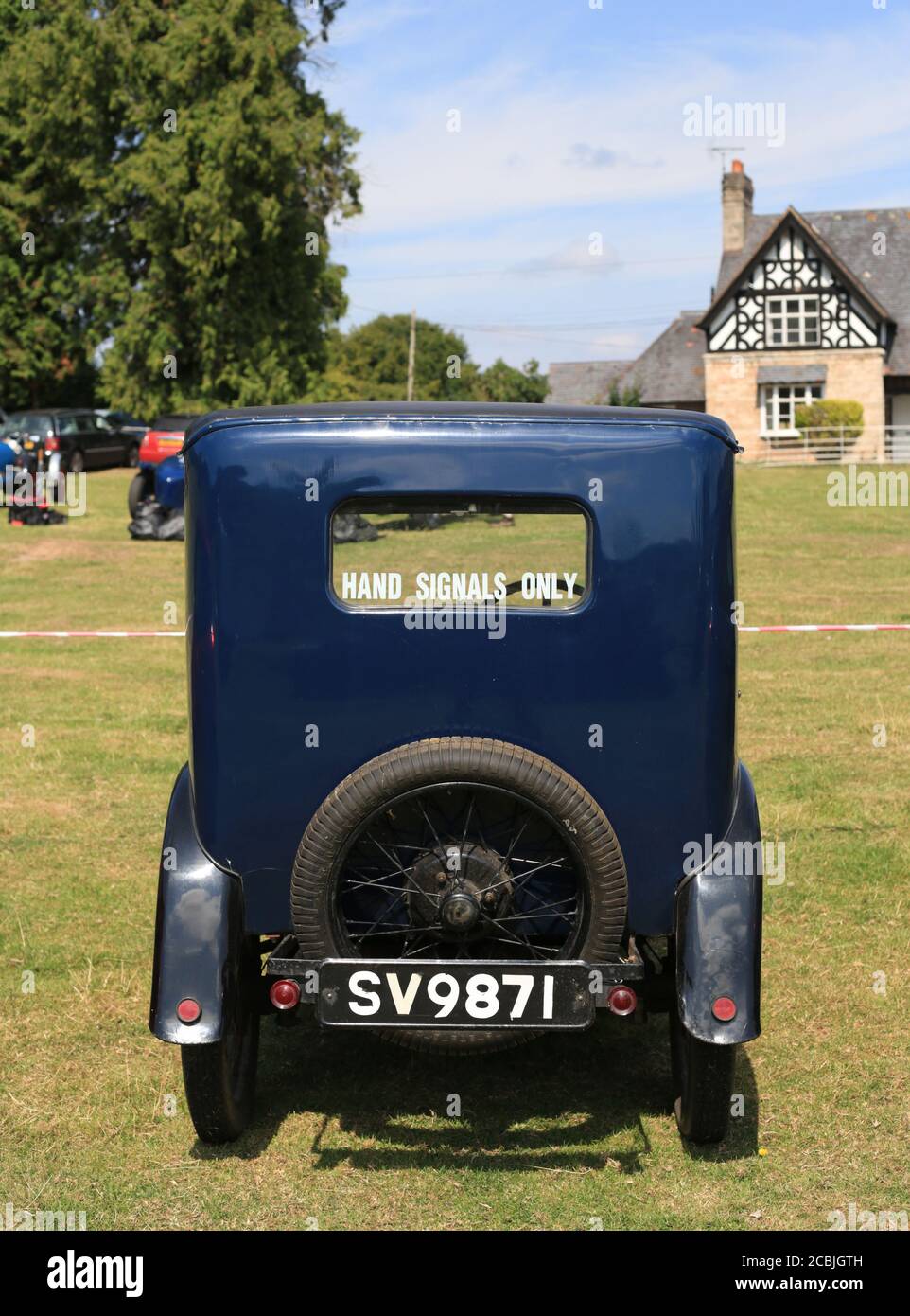 Rear view of a 1930 Austin Seven with a 'hand signals only' sign in the ...