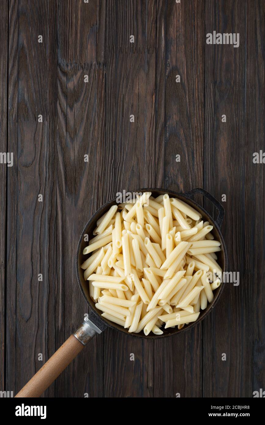 Penne Italian pasta in a frying pan, rustic style.top view Stock Photo -  Alamy