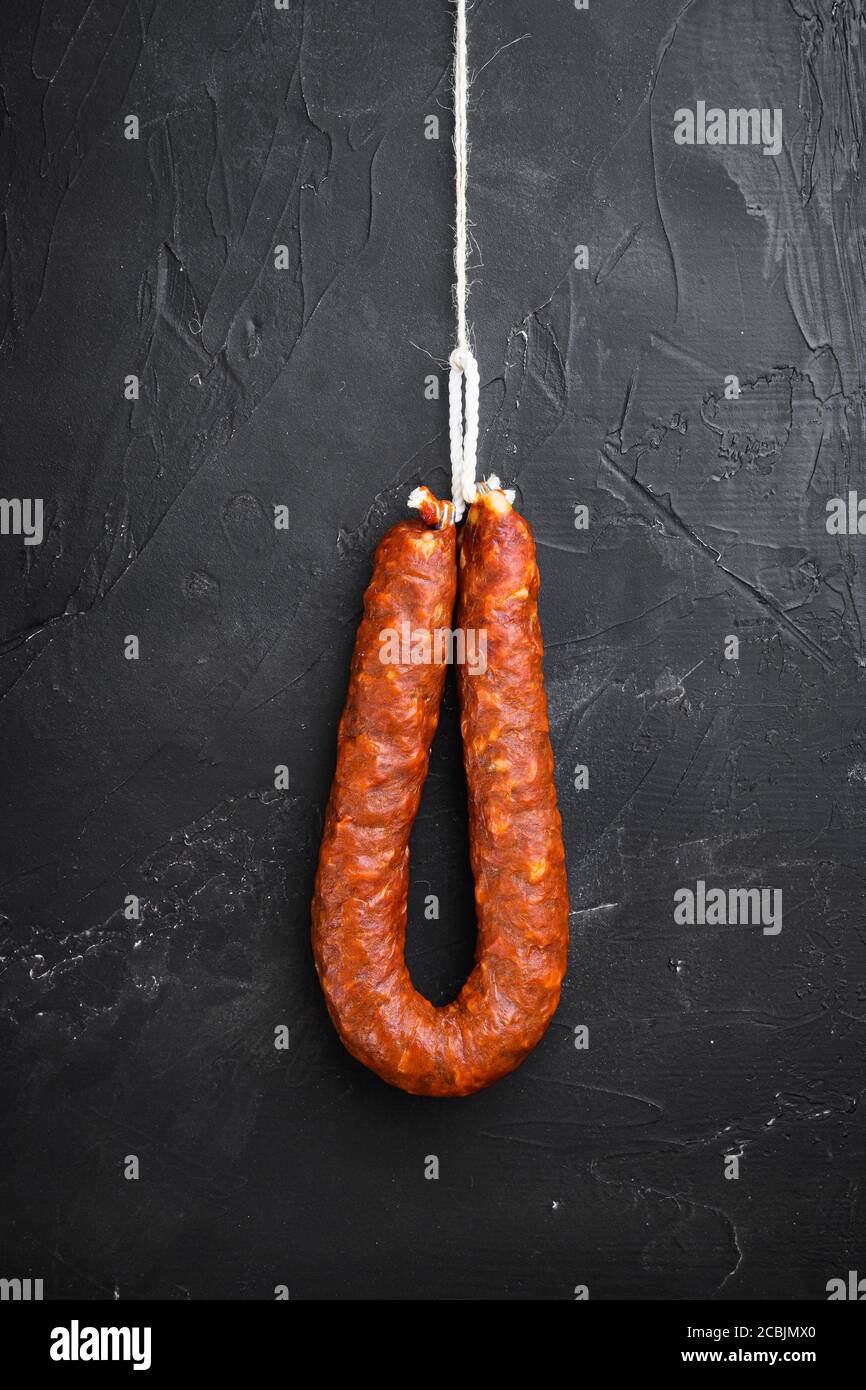 Spanish pork chorizo sausages on black textured background Stock Photo