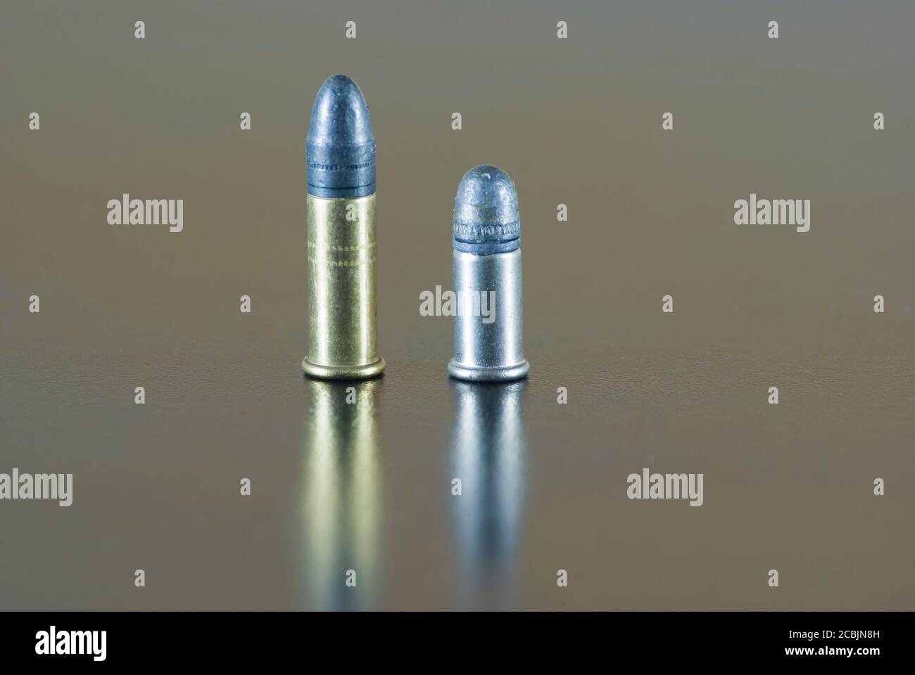 Five .22 rifle rimfire cartridge, short and long, on a table Stock Photo