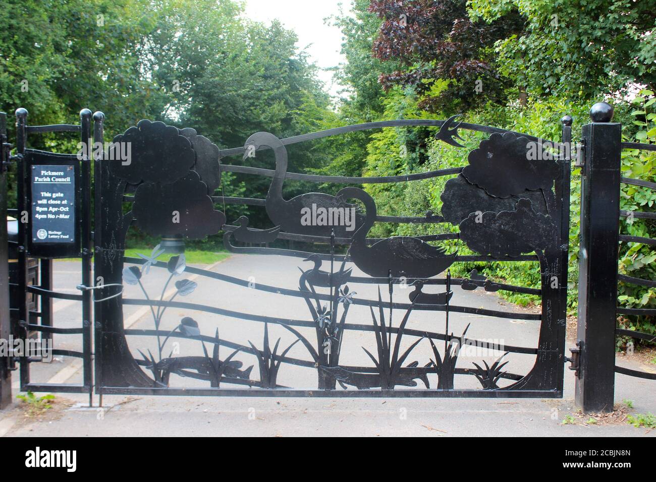 Big, artistic gate guarding Pickmere lake in Cheshire, England Stock Photo