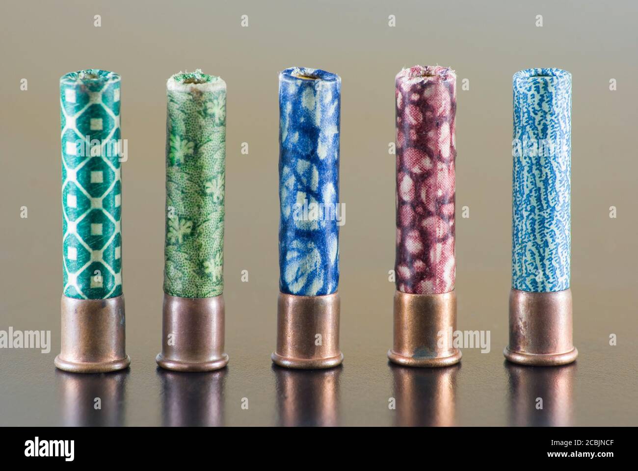 hunting cartridge of different colors in row on a table Stock Photo