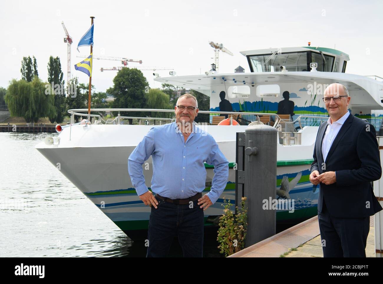 Potsdam, Germany. 14th Aug, 2020. Dietmar Woidke (r, SPD), Minister President of Brandenburg, stands next to Jan Lehmann, Managing Director of the White Fleet, during his press tour in Potsdam Harbour and then goes on board the hybrid passenger ship 'MS Schwielowsee'. Credit: Soeren Stache/dpa-Zentralbild/ZB/dpa/Alamy Live News Stock Photo