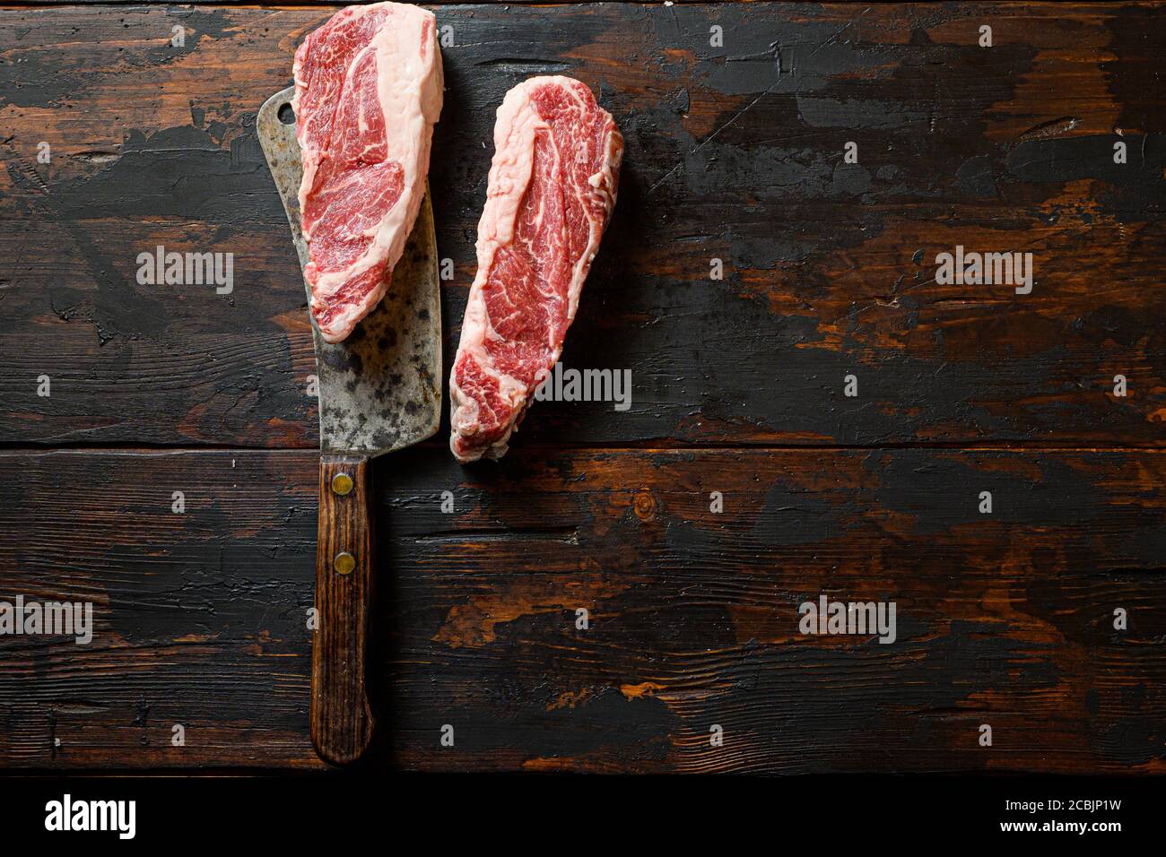 Raw Chuck eye roll steak on meat cleaver. Organic farm cowboy beef