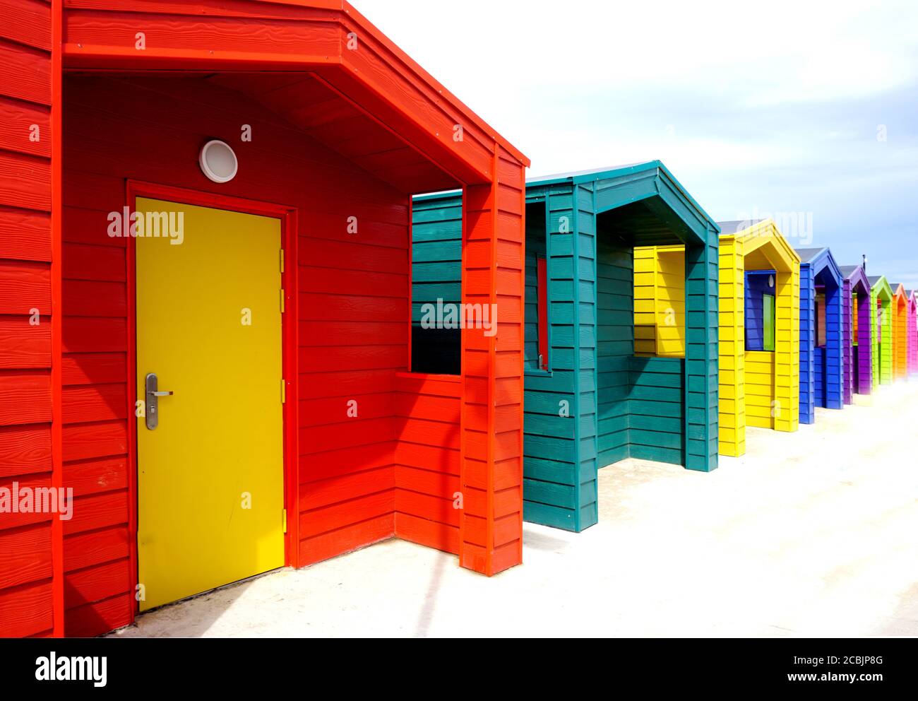 Row of Colourful Seaside Beach Huts Stock Photo