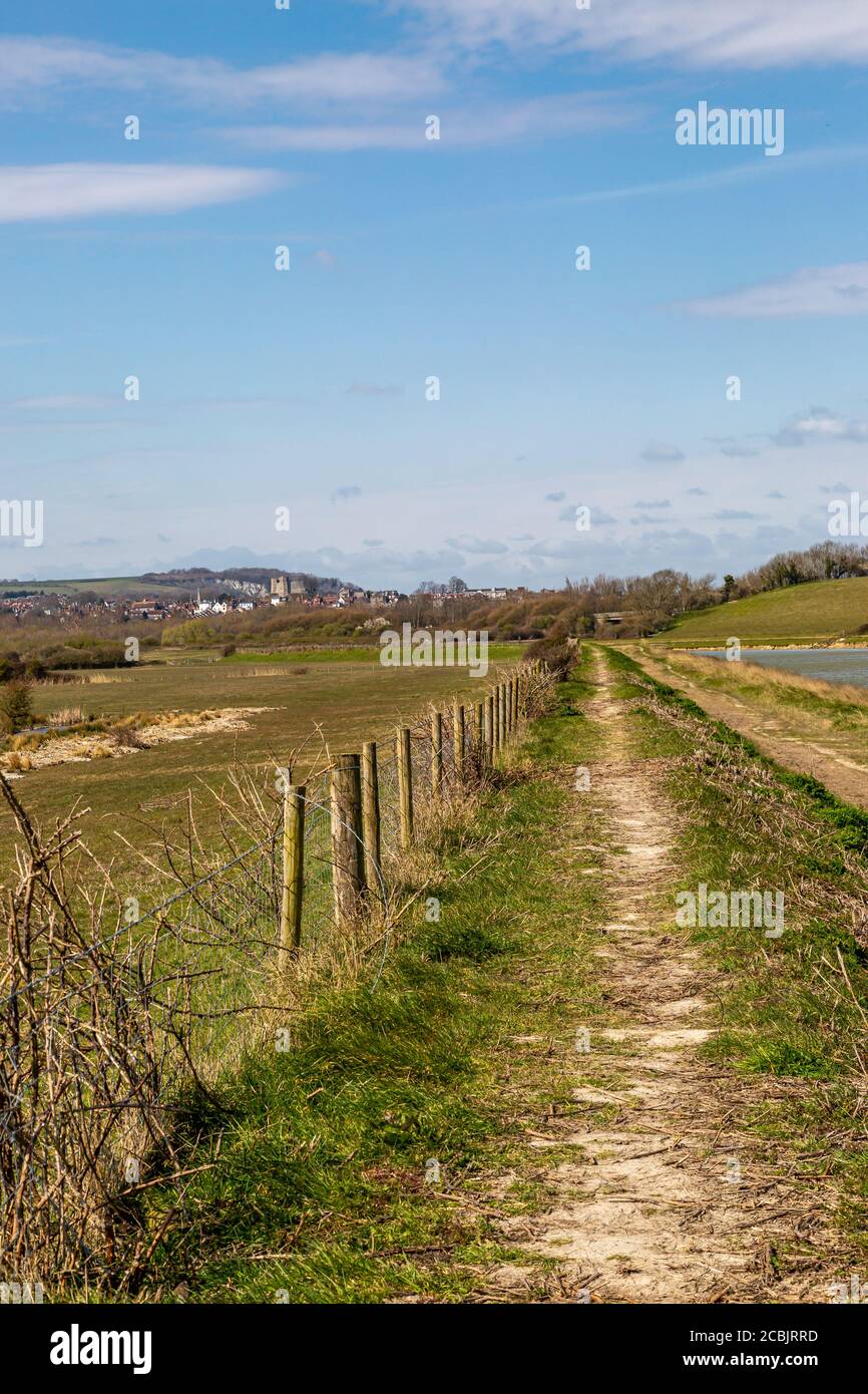 A pathway running alongside the River Ouse in Sussex, with a blue sky overhead Stock Photo