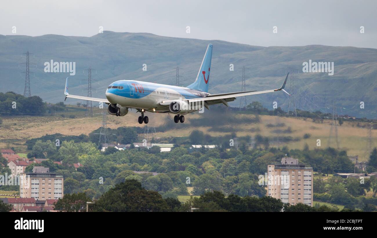 Glasgow, Scotland, UK. 7 August 2020 Pictured: A TUI Airlines Boeing 737-800 passenger plane prepares to land at Glasgow International Airport bringing back holiday makers from Europe. TUI has made huge losses almost £2 billion due to the coronavirus lockdown and customers staying away from holiday destinations as the lockdown eased. Credit: Colin Fisher/Alamy Live News. Stock Photo
