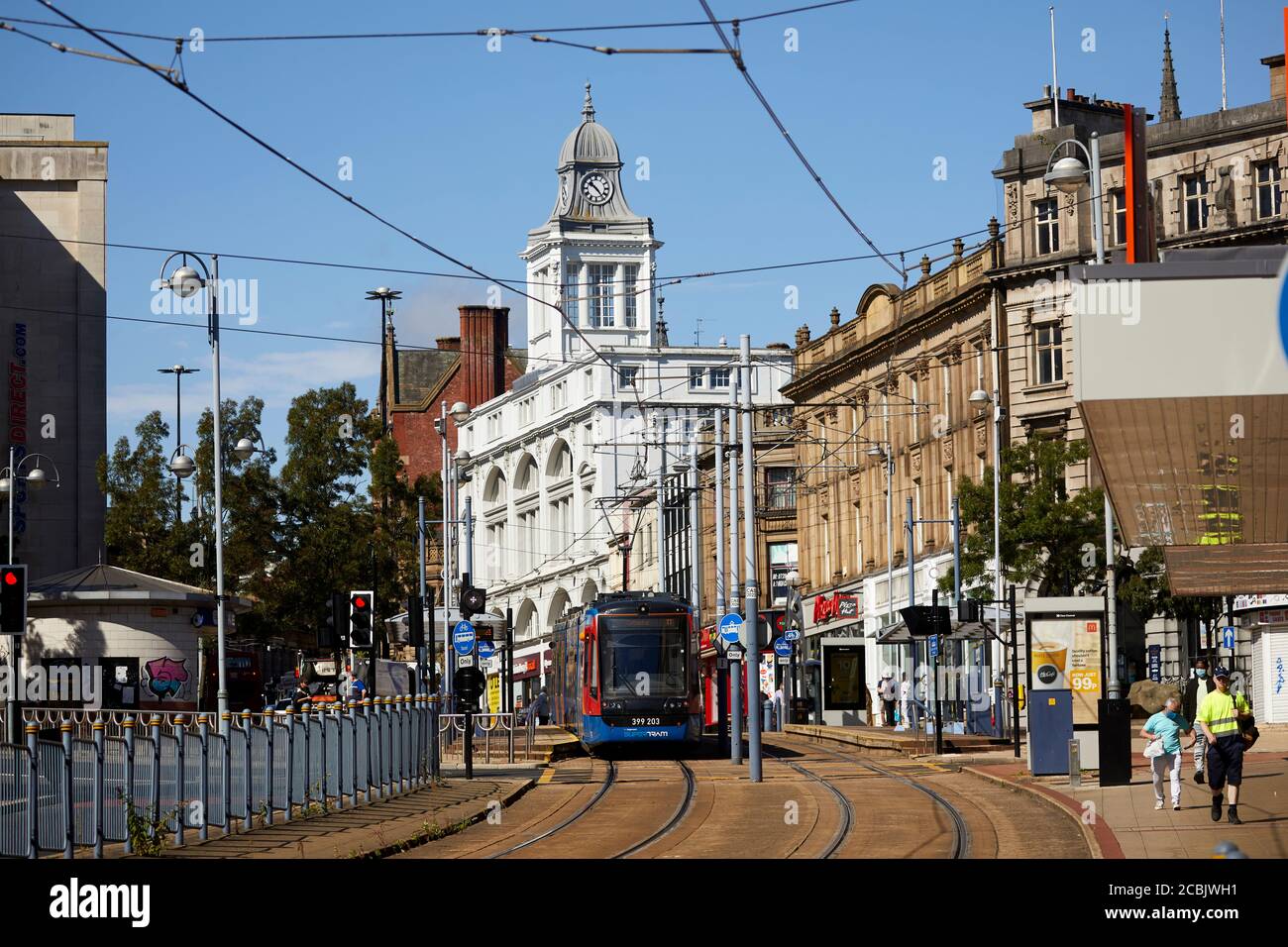 Looking up Commercial Street to High Street with white building  Grade II listed Telegraph House and Stagecoach Super Trams in Sheffield city centre Stock Photo