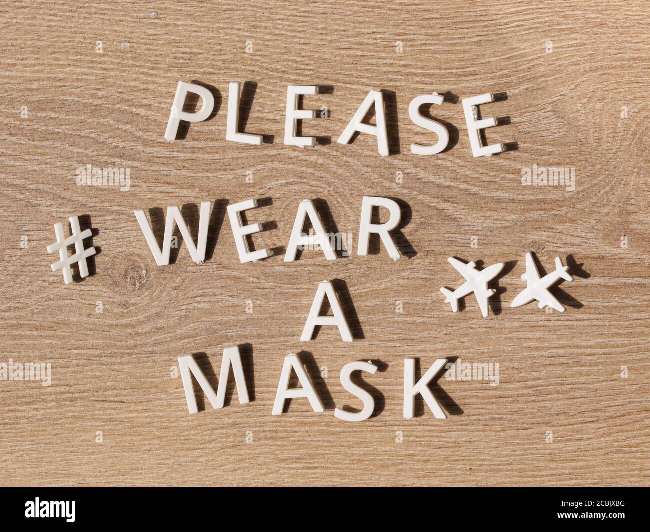 hashtag wear a mask. preventive health care notice sign with text PLEASE WEAR A MASK at entrance for coronavirus prevention. Compulsory measure in air Stock Photo