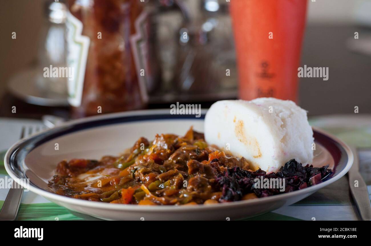 Nsima, also known as ugali or posho, is a main meal for millions in Africa. A popular combination with nyama choma Stock Photo