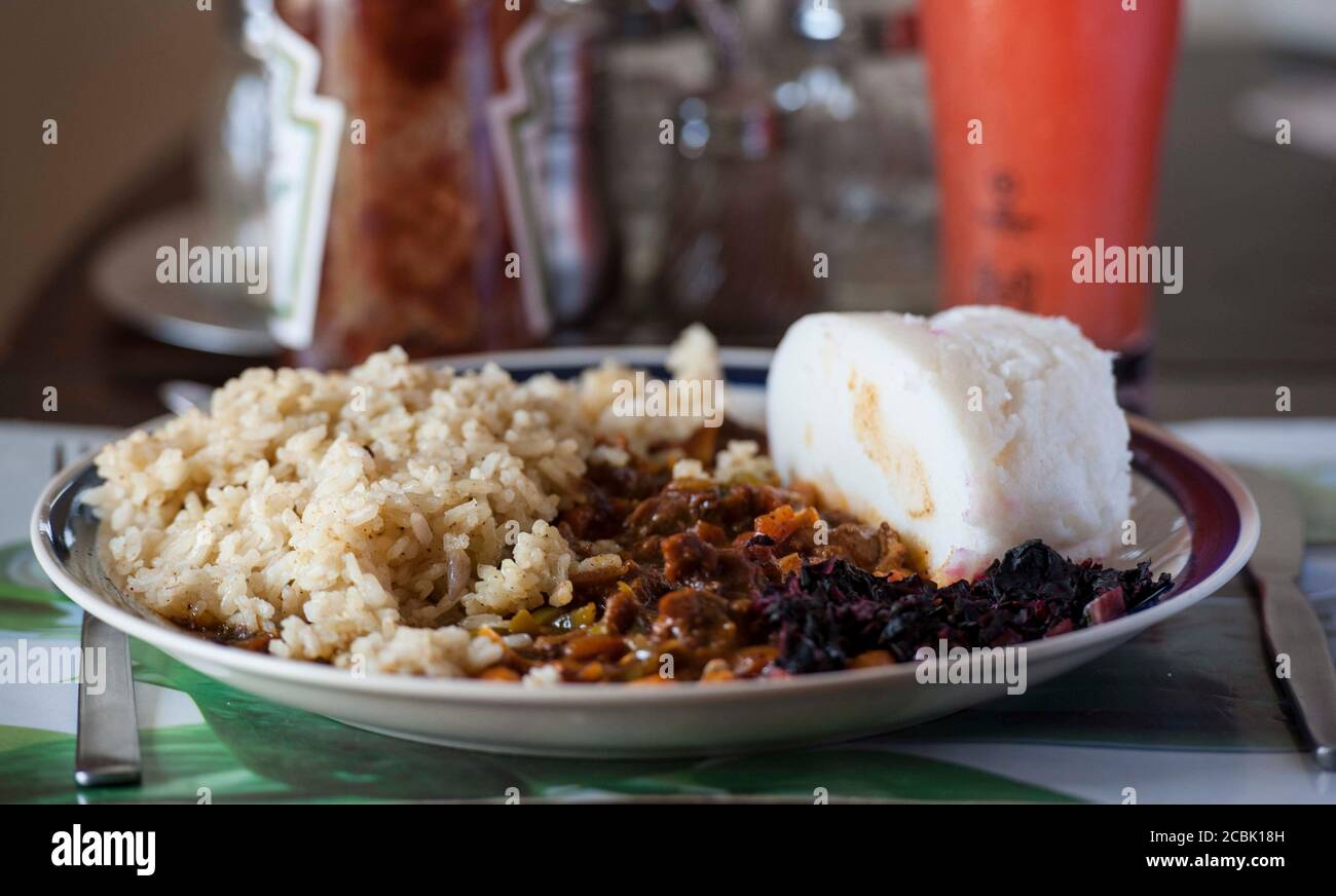 Nsima, also known as ugali or posho, is a main meal for millions in Africa. A popular combination with nyama choma and rice Stock Photo