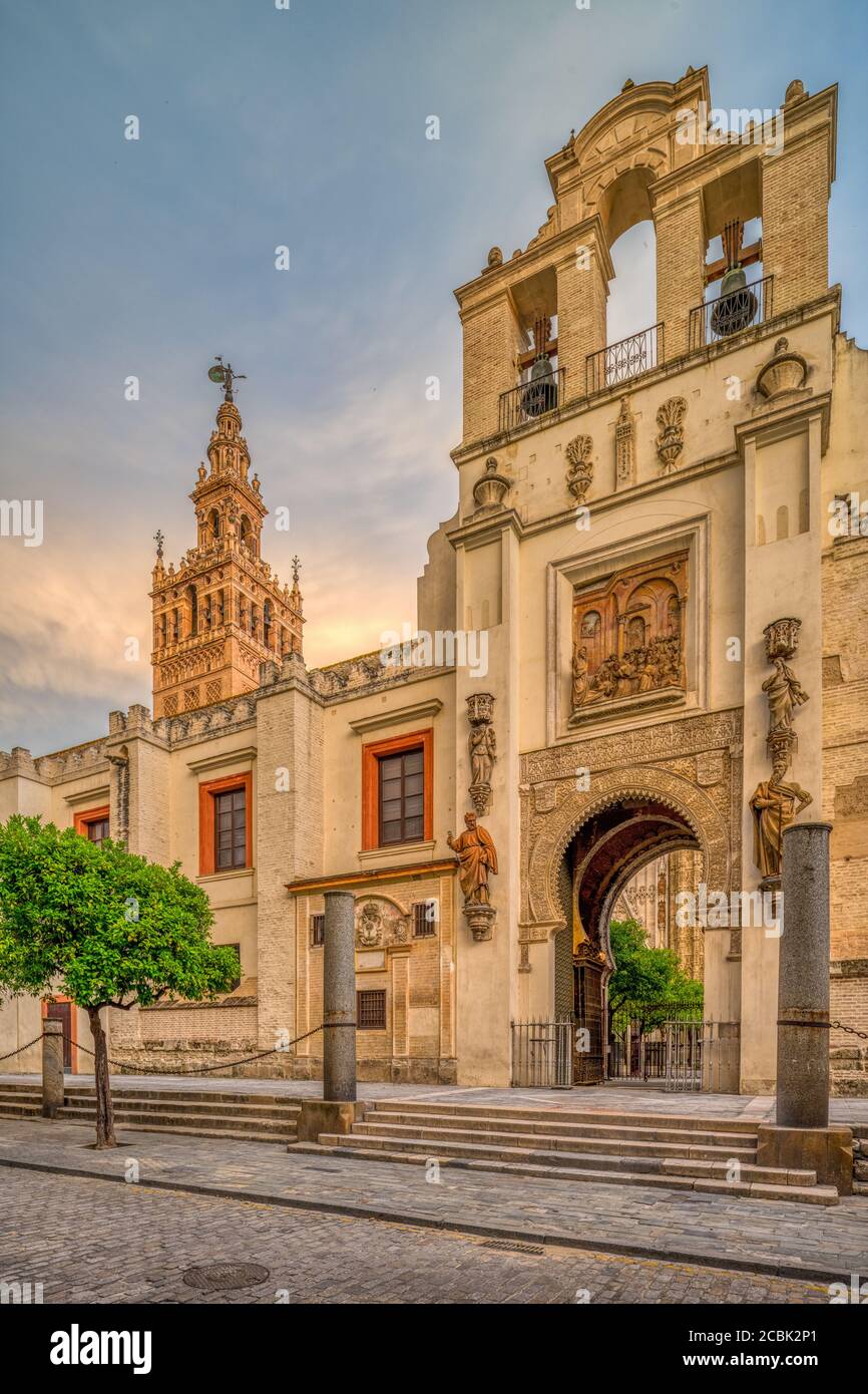 Puerta del Pedon (Door of Forgiveness) with the Giralda tower on the background, Seville, Spain Stock Photo