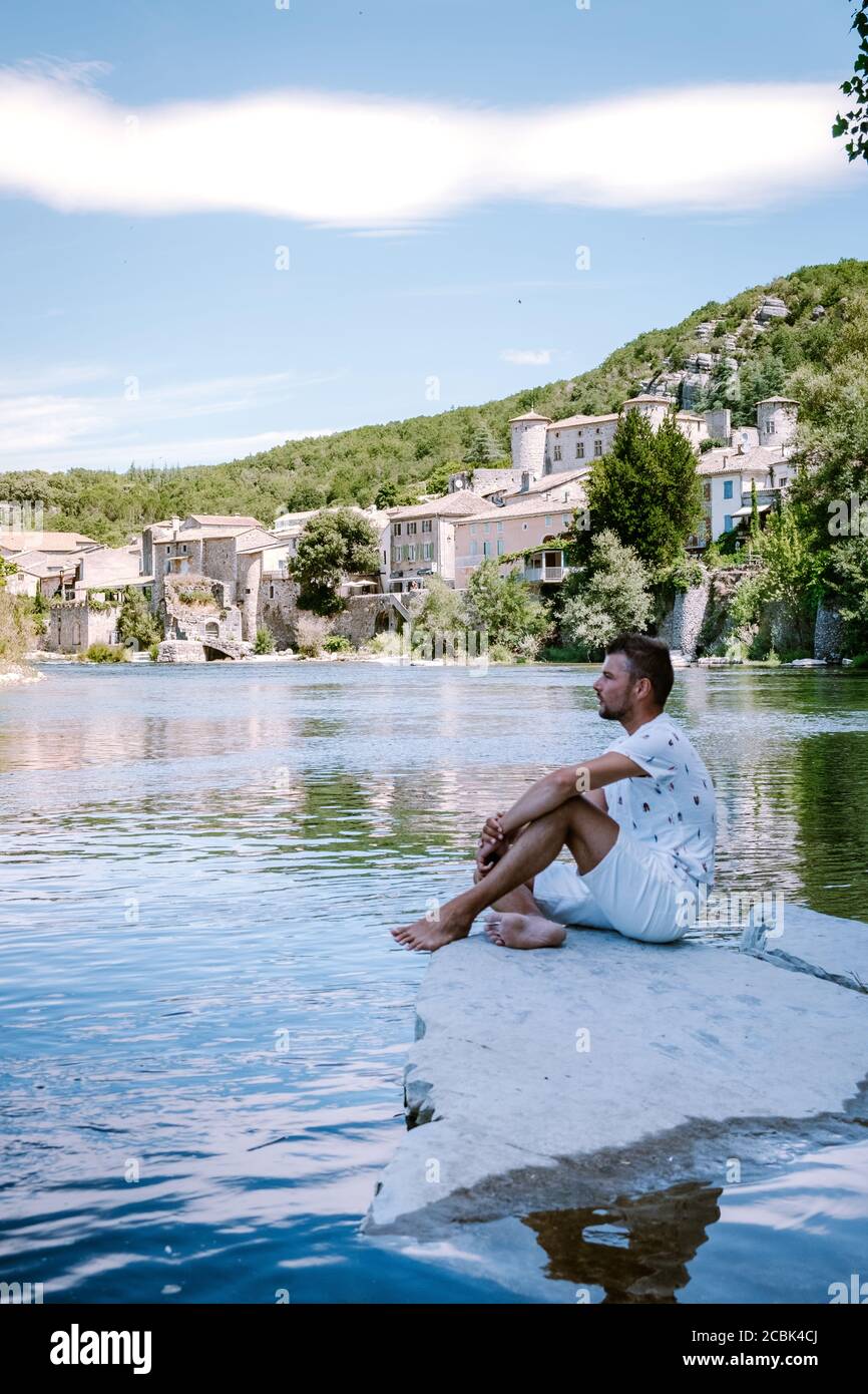 guy on vacation in Ardeche France, view of the village of Vogue in Ardeche. France Stock Photo