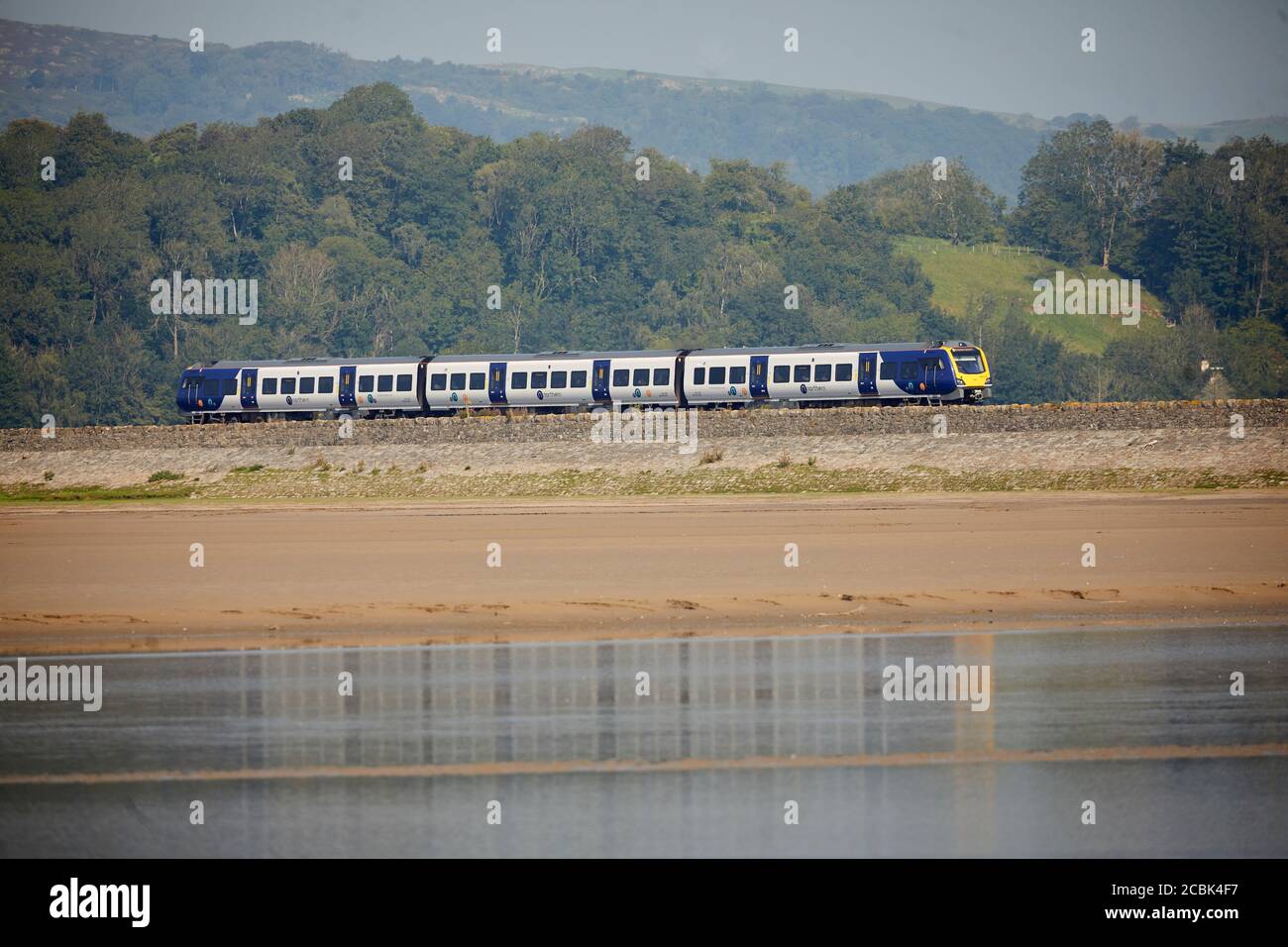 British Rail Class 195 Civity diesel multiple-unit passenger train manufactured by CAF operated by Northern Trains leaves Grange-over-Sands along to c Stock Photo