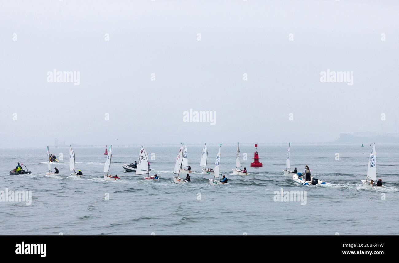 Crosshaven, Cork, Ireland. 14th August, 2020.  Dinghies been towed out  at the start of the second day of competition in the Optimist Irish National Championships that are been held in Crosshaven, Co. Cork, Ireland. - Credit; David Creedon / Alamy Live News Stock Photo