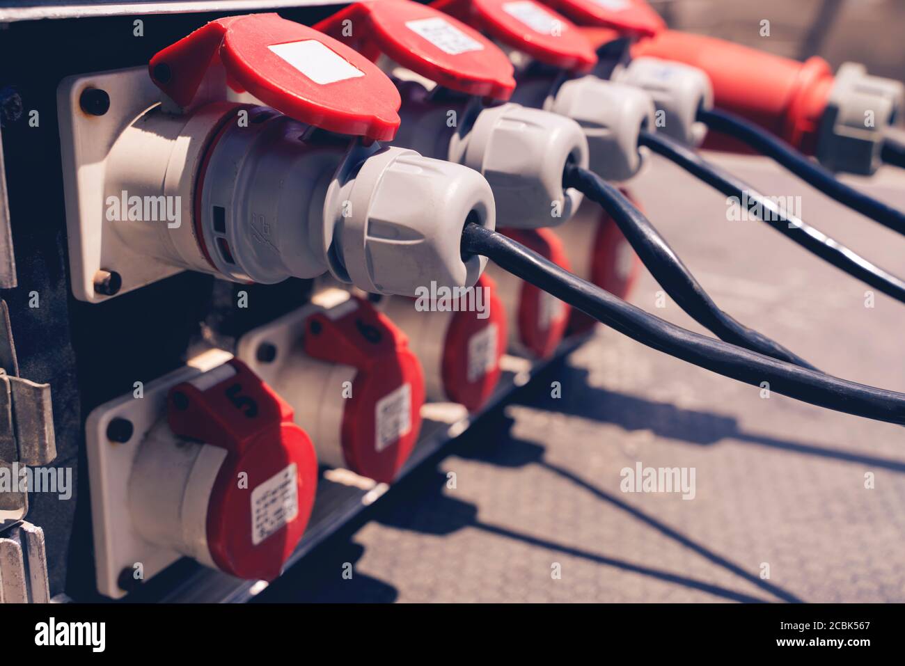 Plug in the power cord, many outlets with black plugs plugged in close