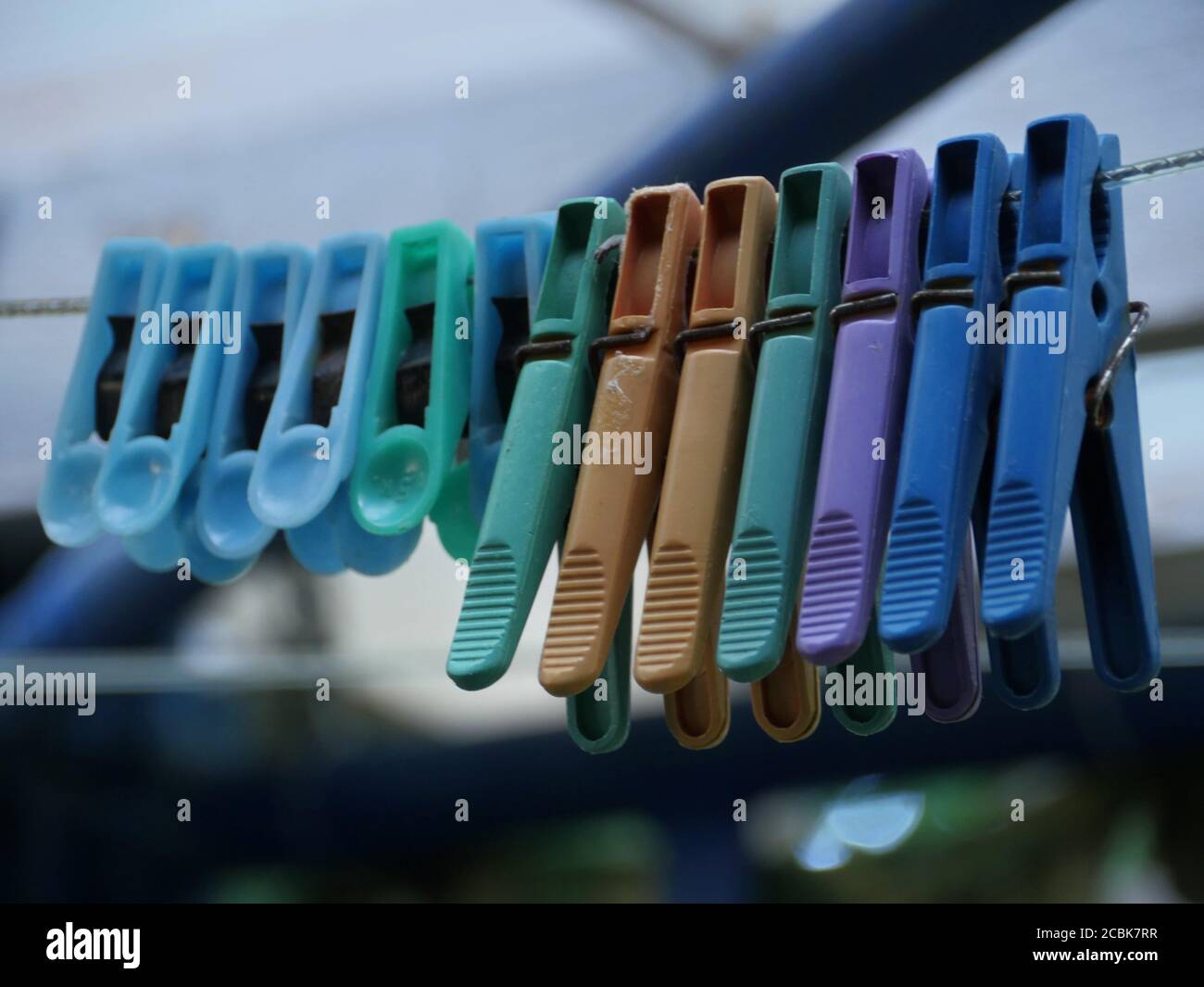 colored clothespins on the rope close-up Stock Photo