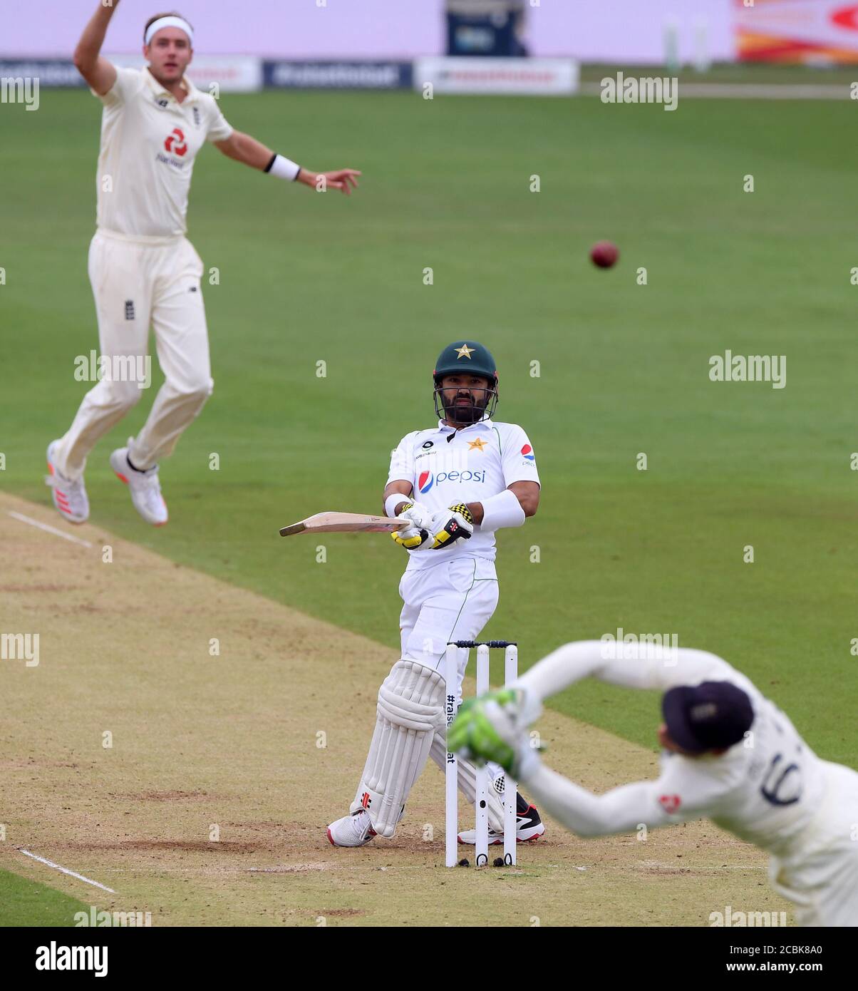 England's Jos Buttler dives to attempt to catch the ball off a shot from Pakistan's Mohammad Rizwan from the bowling of Stuart Broad (left) during day two of the Second Test match at the Ageas Bowl, Southampton. Stock Photo