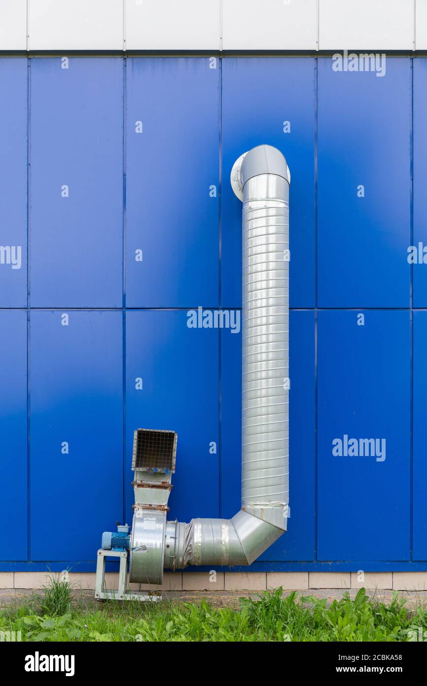 industrial grade air extraction duct with electrical motor on blue wall