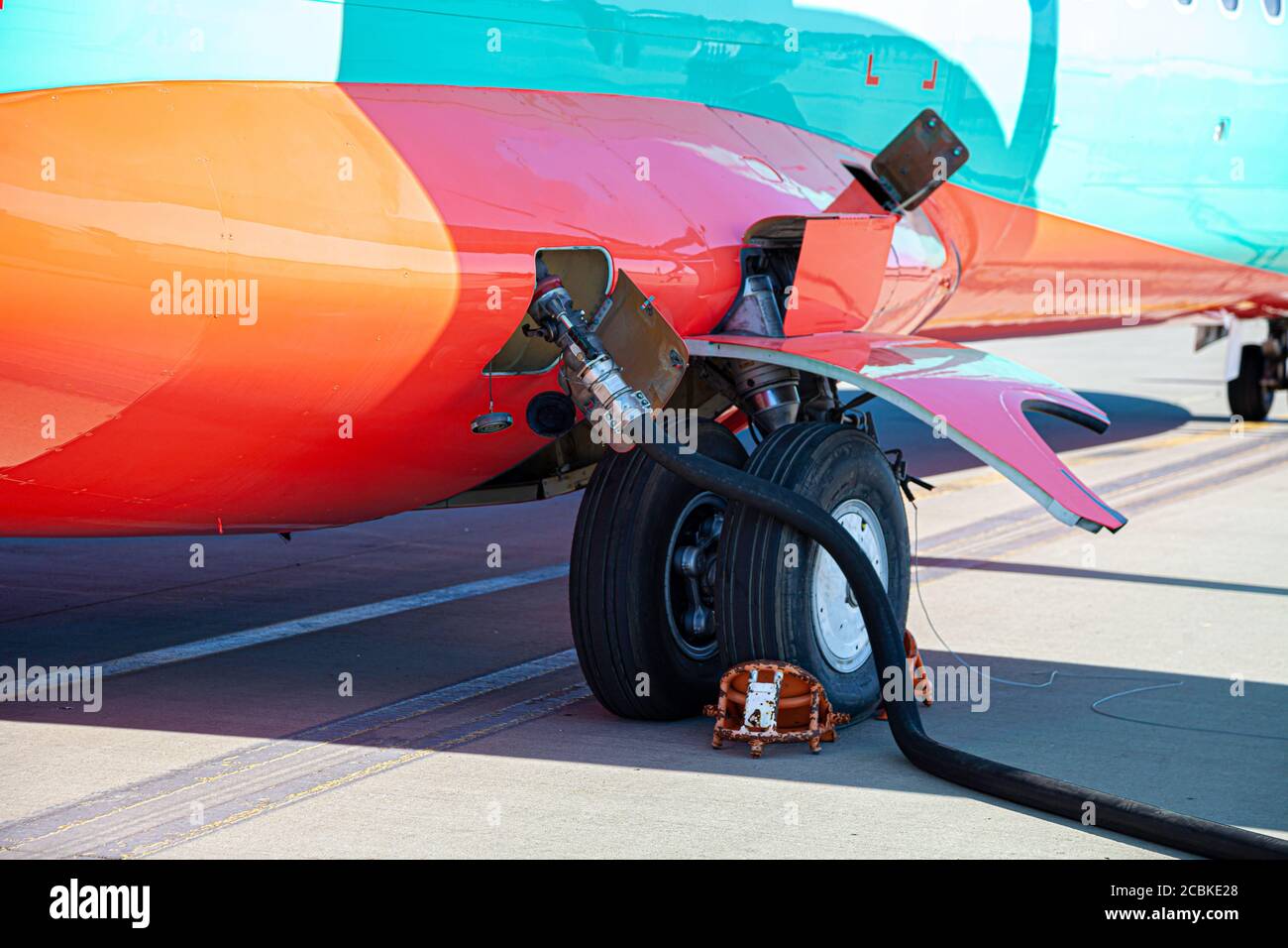 Refueling the plane. Filling tank and gun. Fuel supply through a hose. Weel. Stock Photo