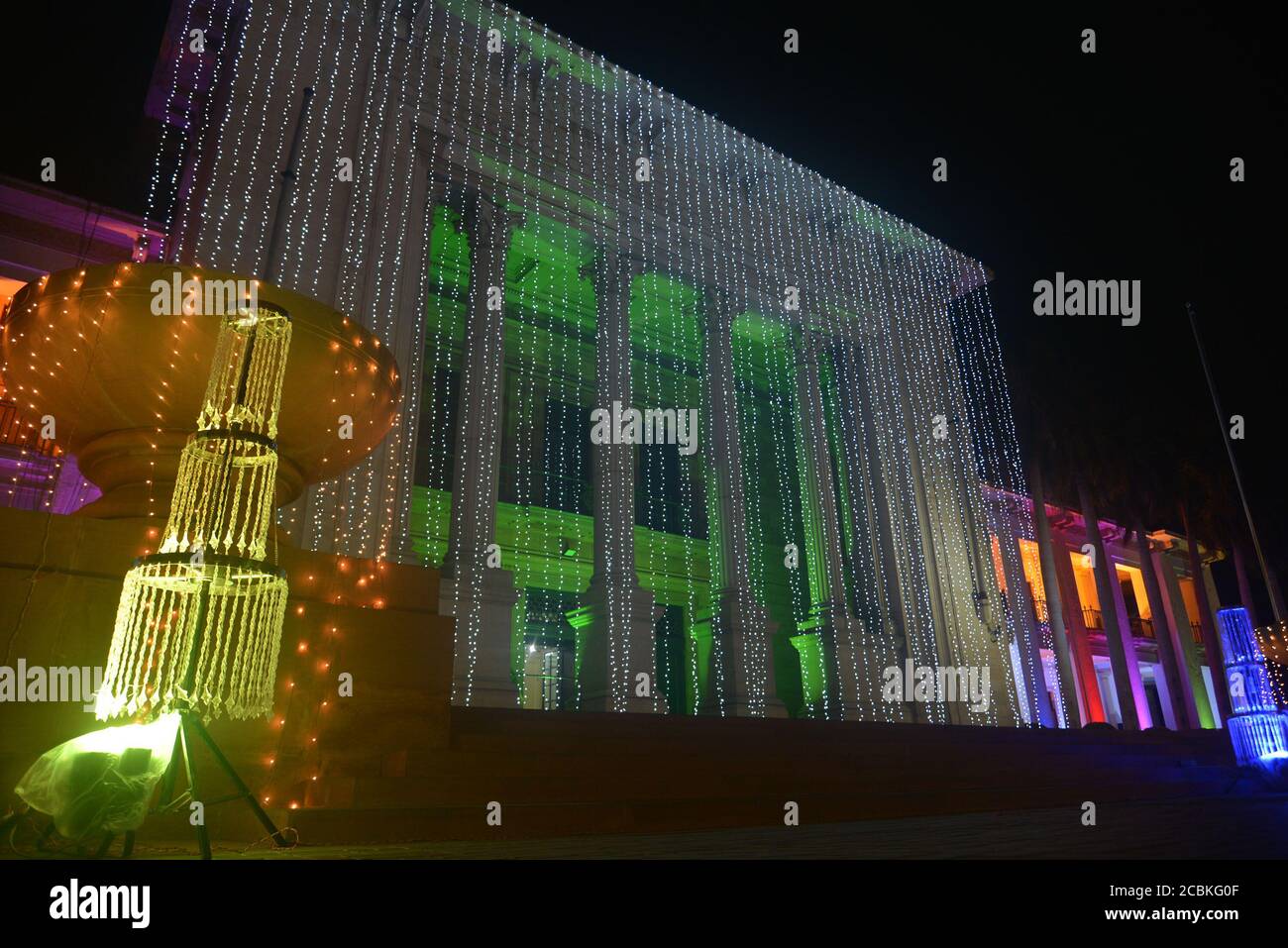 A wonderful view of the Town Hall, Wapda House, Punjab Assembly at mall road which is illuminated with colorful lights as the nation starts preparing for the 73rd Independence Day (National Day) celebration in Lahore. As the nation starts preparing to 73rd celebrate the Independence Day of Pakistan in befitting manners, printing presses are busy day and night to print the items that are in great demand. Besides, vehicles could be seen on roads painted with national flag colors, which shows the enthusiasm of the people to commemorate the country's Independence Day.The annual celebration is ever Stock Photo