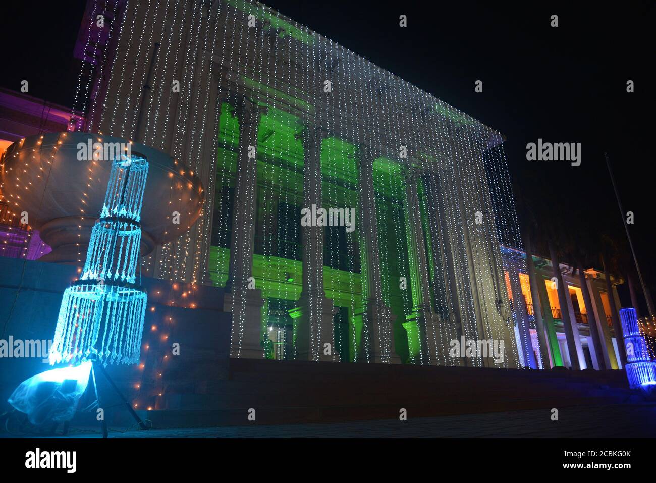 A wonderful view of the Town Hall, Wapda House, Punjab Assembly at mall road which is illuminated with colorful lights as the nation starts preparing for the 73rd Independence Day (National Day) celebration in Lahore. As the nation starts preparing to 73rd celebrate the Independence Day of Pakistan in befitting manners, printing presses are busy day and night to print the items that are in great demand. Besides, vehicles could be seen on roads painted with national flag colors, which shows the enthusiasm of the people to commemorate the country's Independence Day.The annual celebration is ever Stock Photo