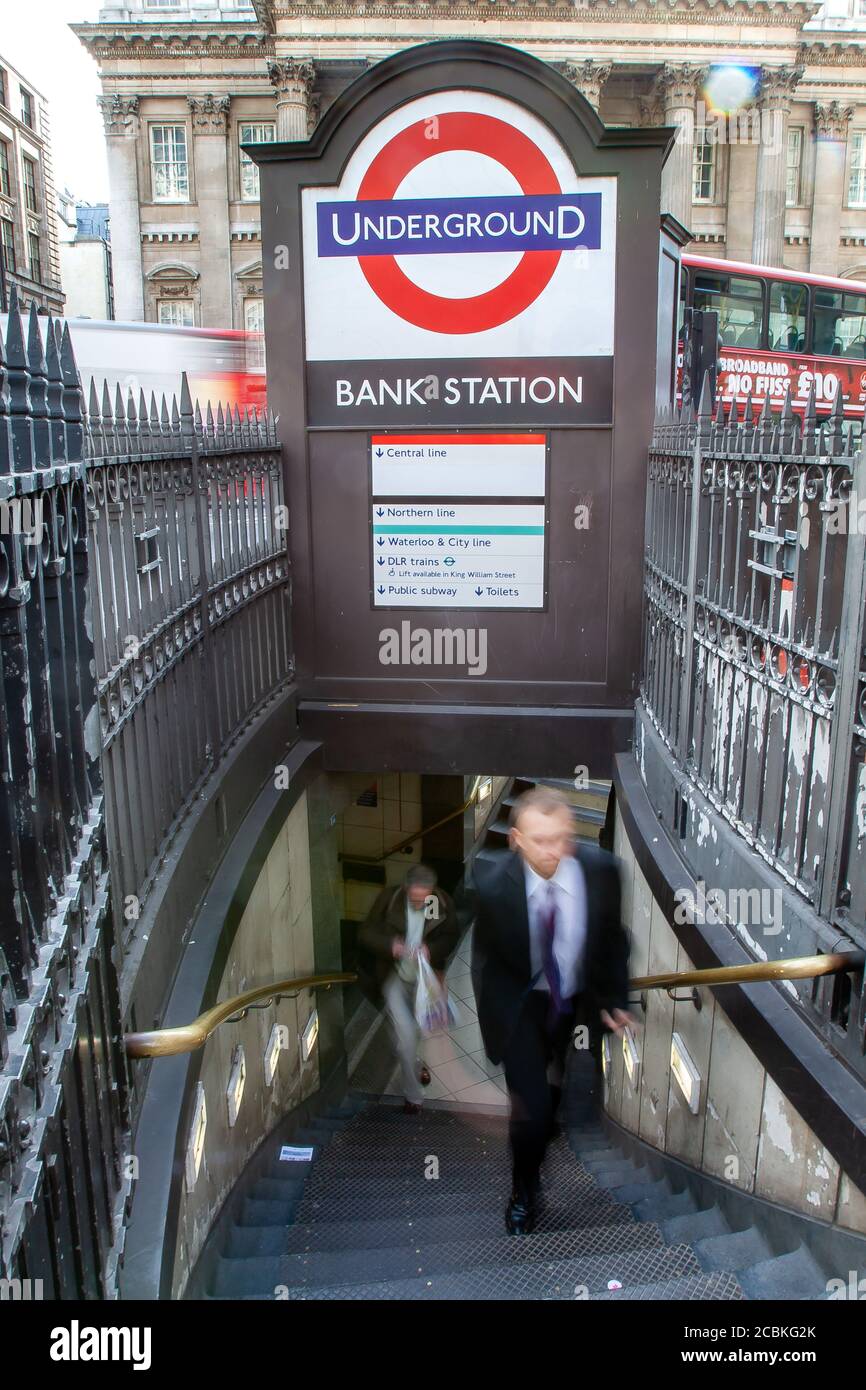 Pedestrian walks up the stairs from the Bank London Underground Station in the Square Mile of the City of London in the aftermath of the credit crunch Stock Photo