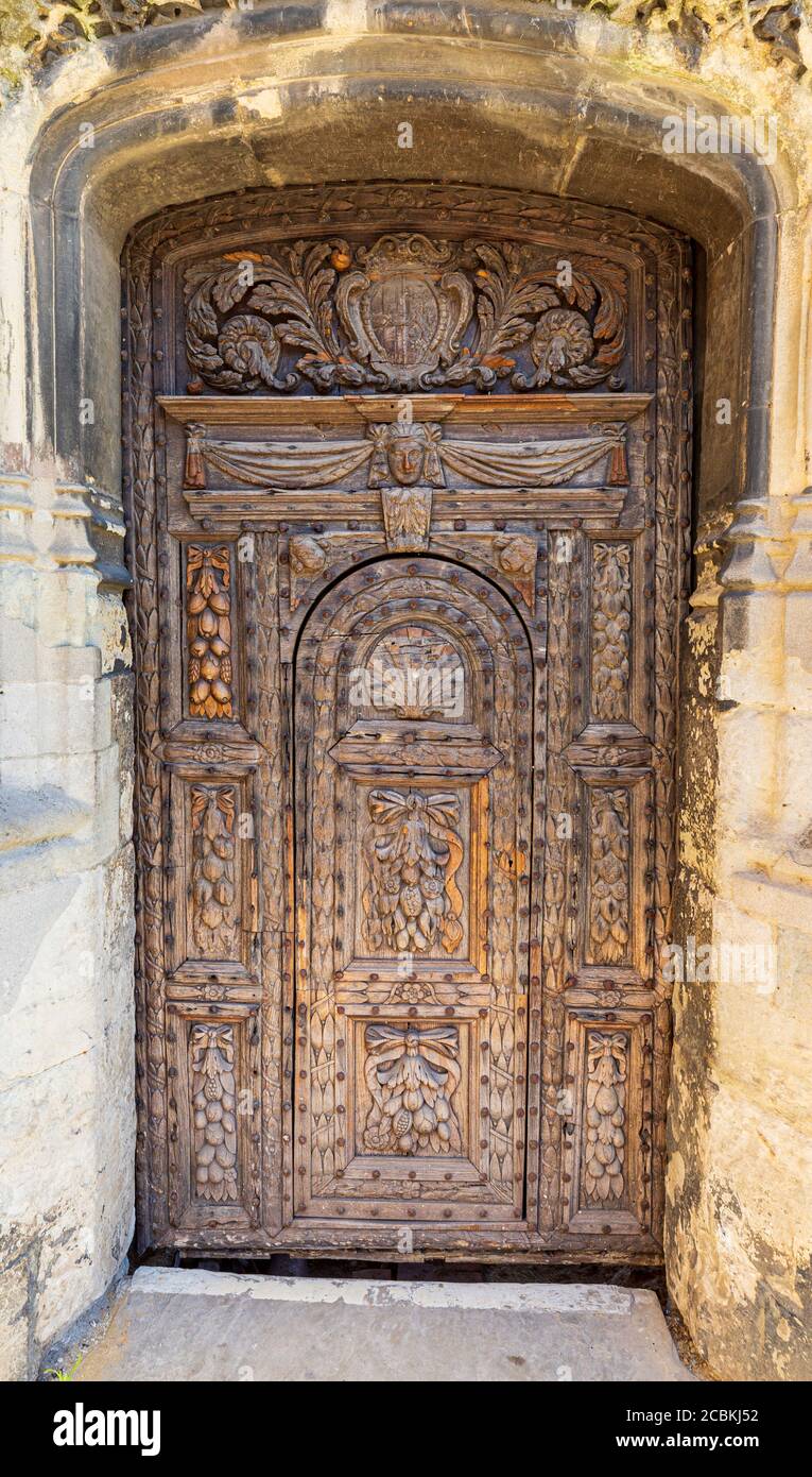 The ornate carved oak entrance door of Christchurch Gate at Canterbury