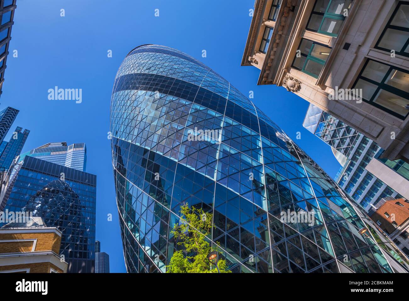 England, London, The Swiss Re building 30 St Mary Axe, alternatively known as the Gherkin, commercial skyscraper designed by architect Sir Norman Fost Stock Photo