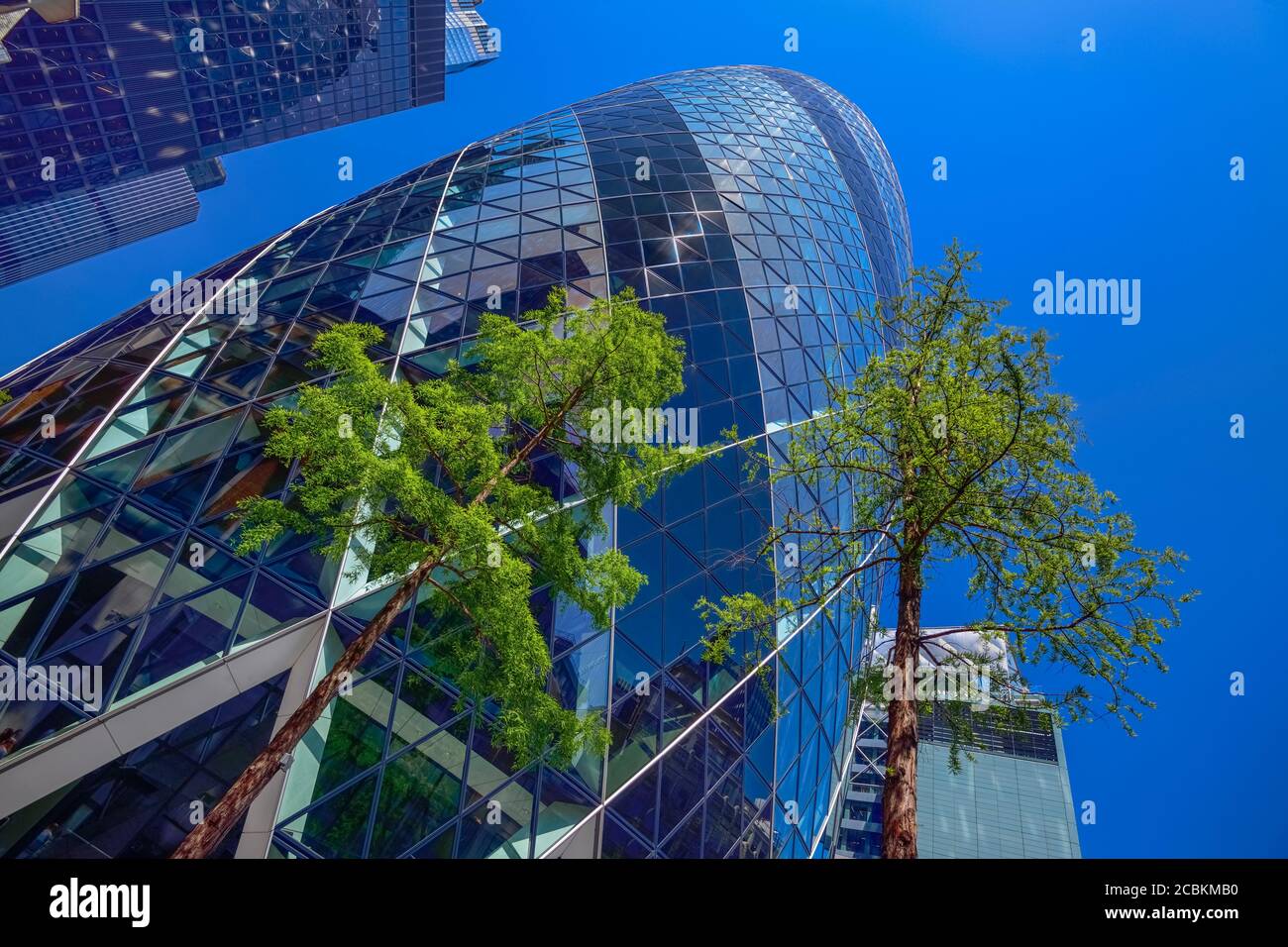 England, London, The Swiss Re building 30 St Mary Axe, alternatively known as the Gherkin, commercial skyscraper designed by architect Sir Norman Fost Stock Photo