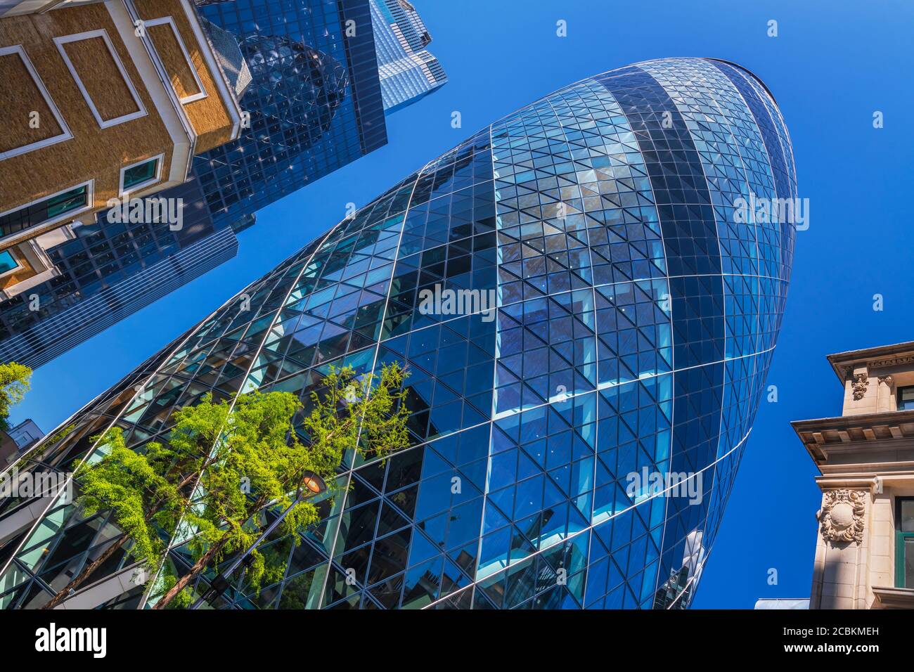 England, London, The Swiss Re building 30 St Mary Axe, alternatively known as the Gherkin, commercial skyscraper designed by architect Sir Norman Fost Stock Photo