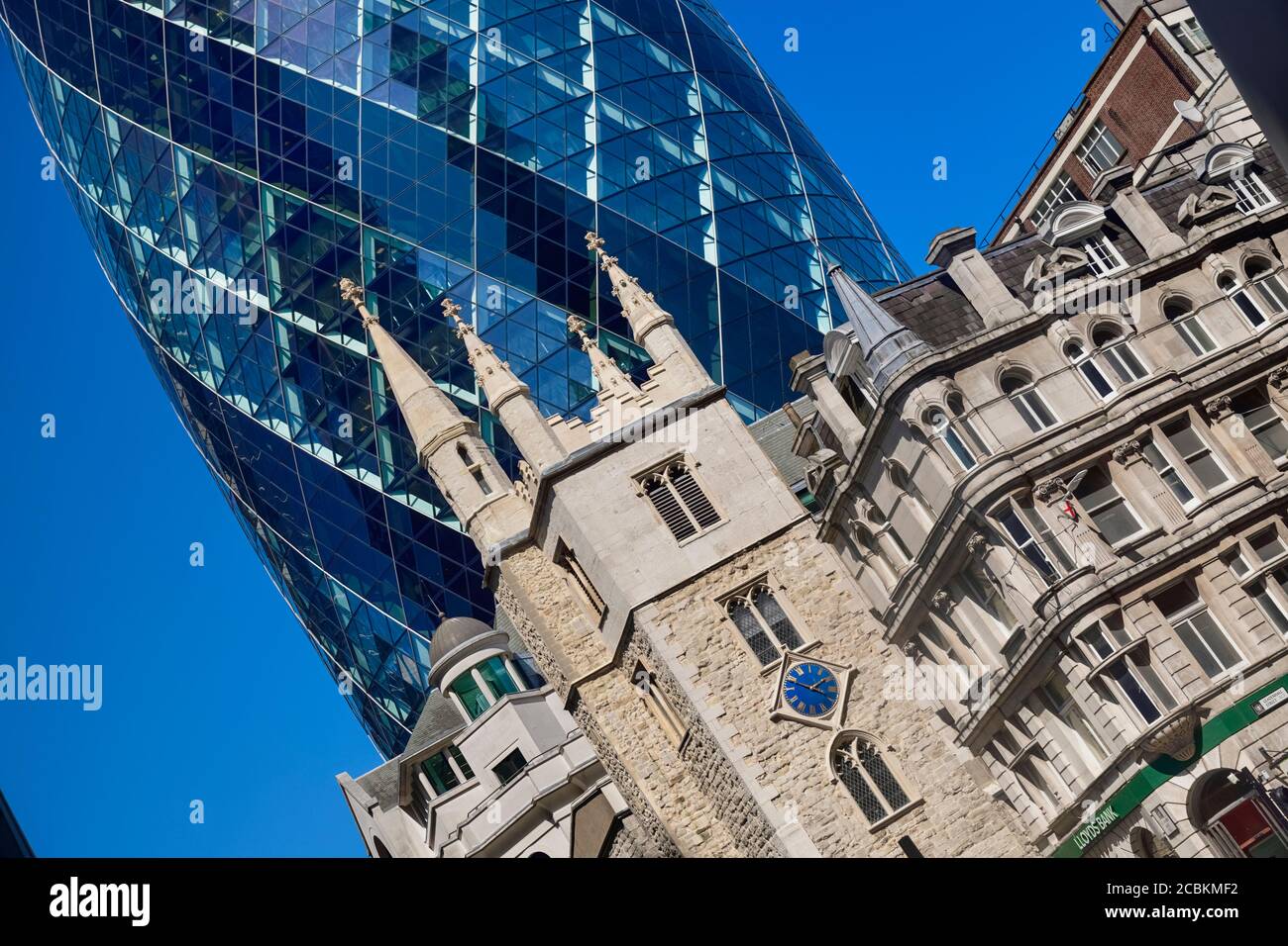 England, London, The Swiss Re building 30 St Mary Axe, alternatively known as the Gherkin, commercial skyscraper designed by architect Sir Norman Fost Stock Photo