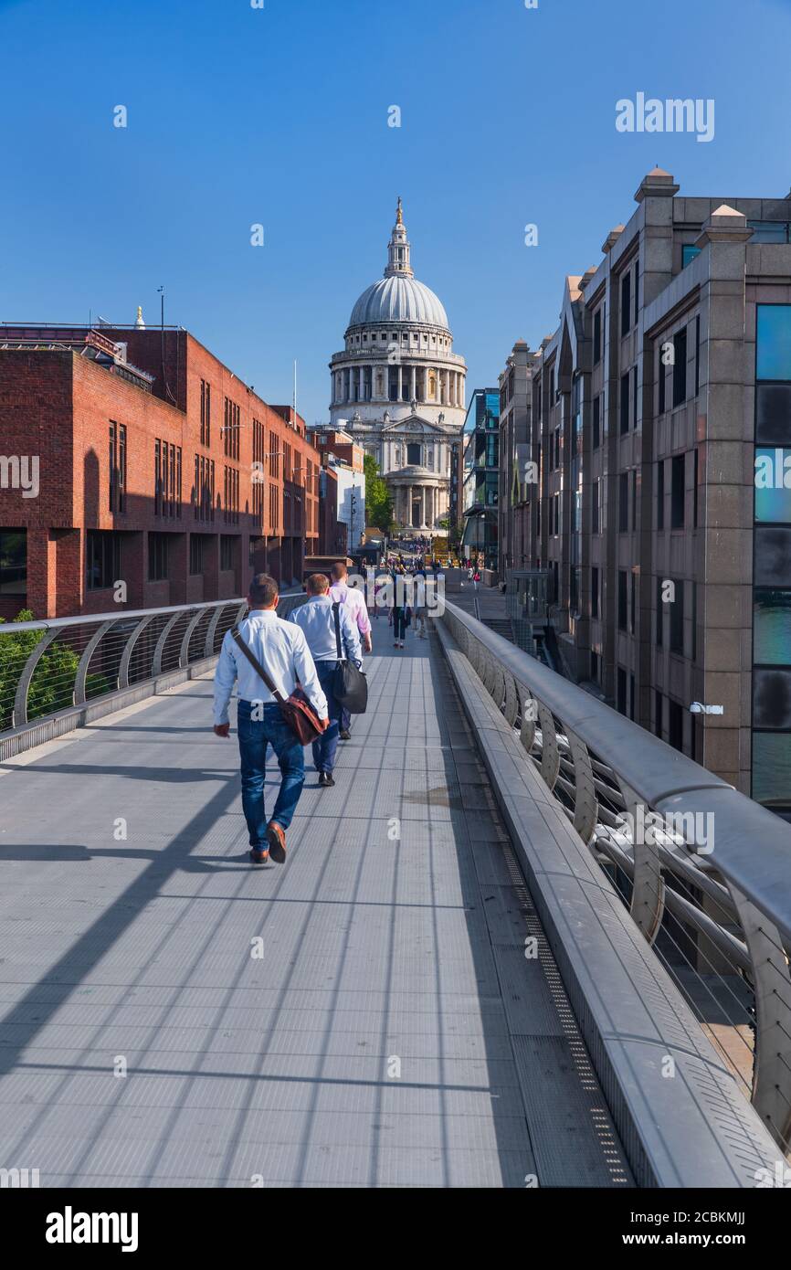 England, London, City workers crossing the Millennium Bridge towards St Paul’s Cathedral. Stock Photo