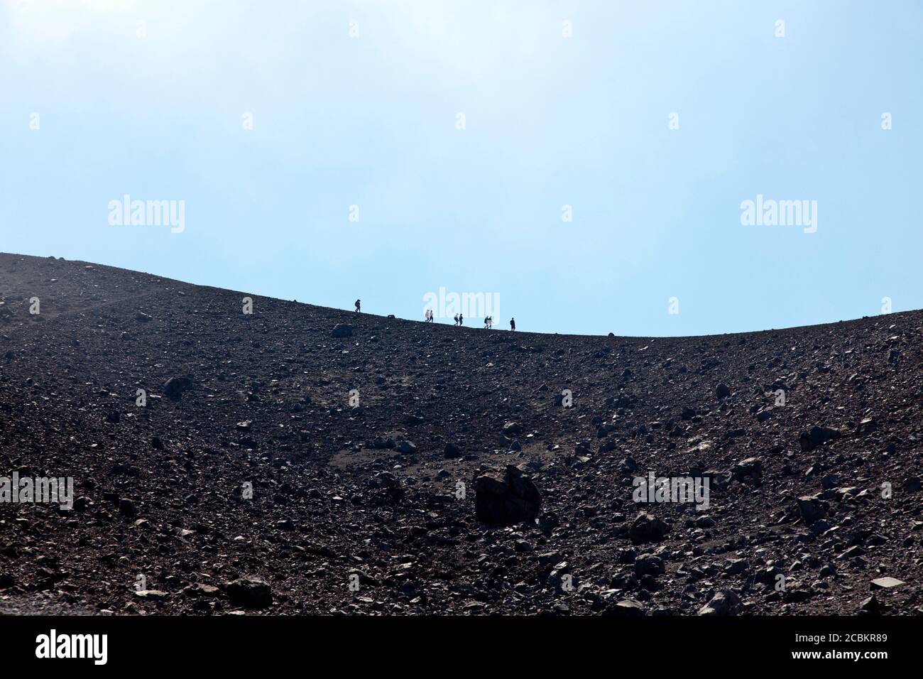Silhouette of hikers on rocky slope Stock Photo - Alamy