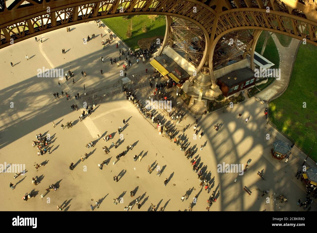 Tourists under Eiffel Tower in Paris Stock Photo