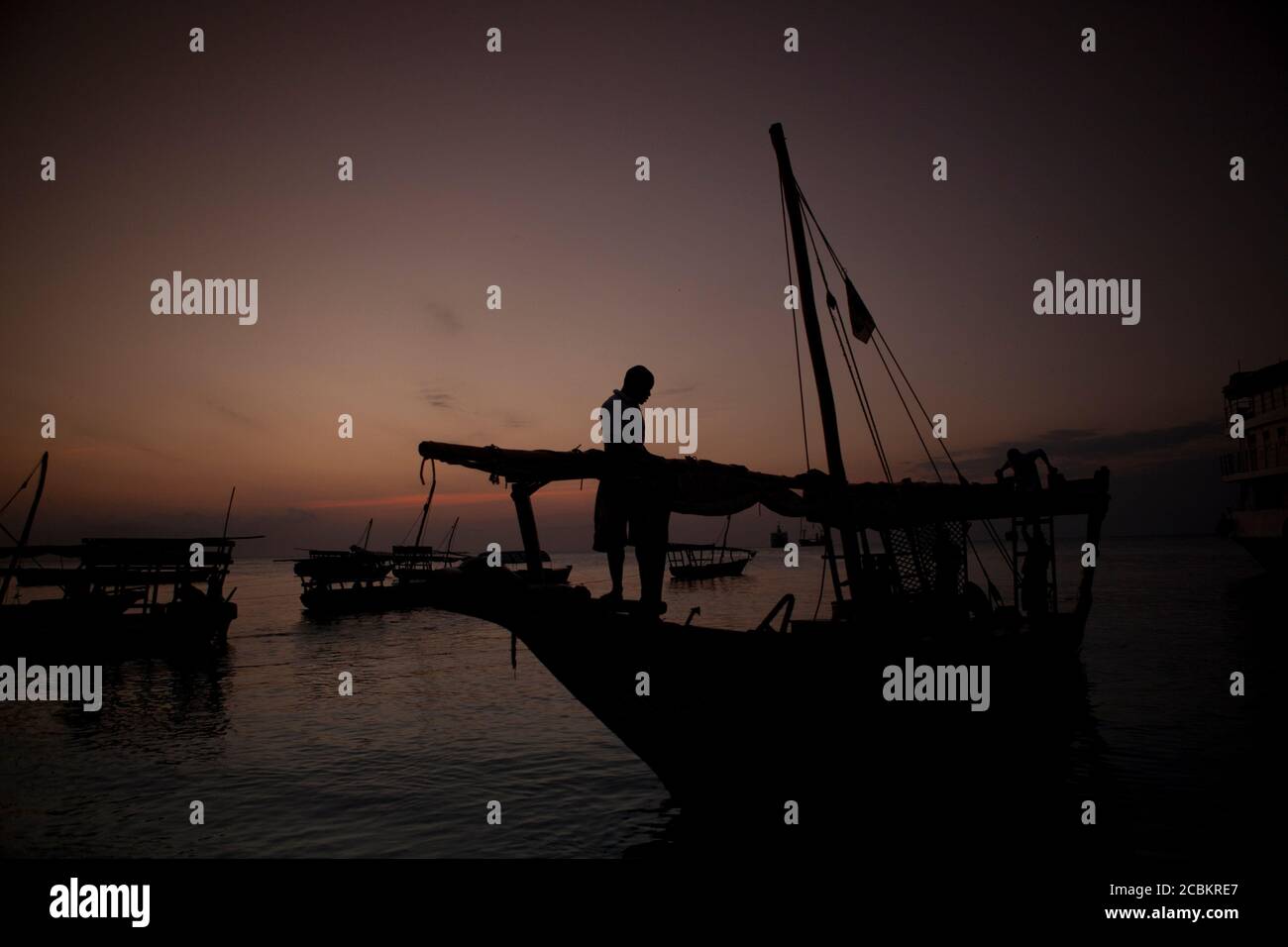 Silhouette of fisherman on boat Stock Photo - Alamy