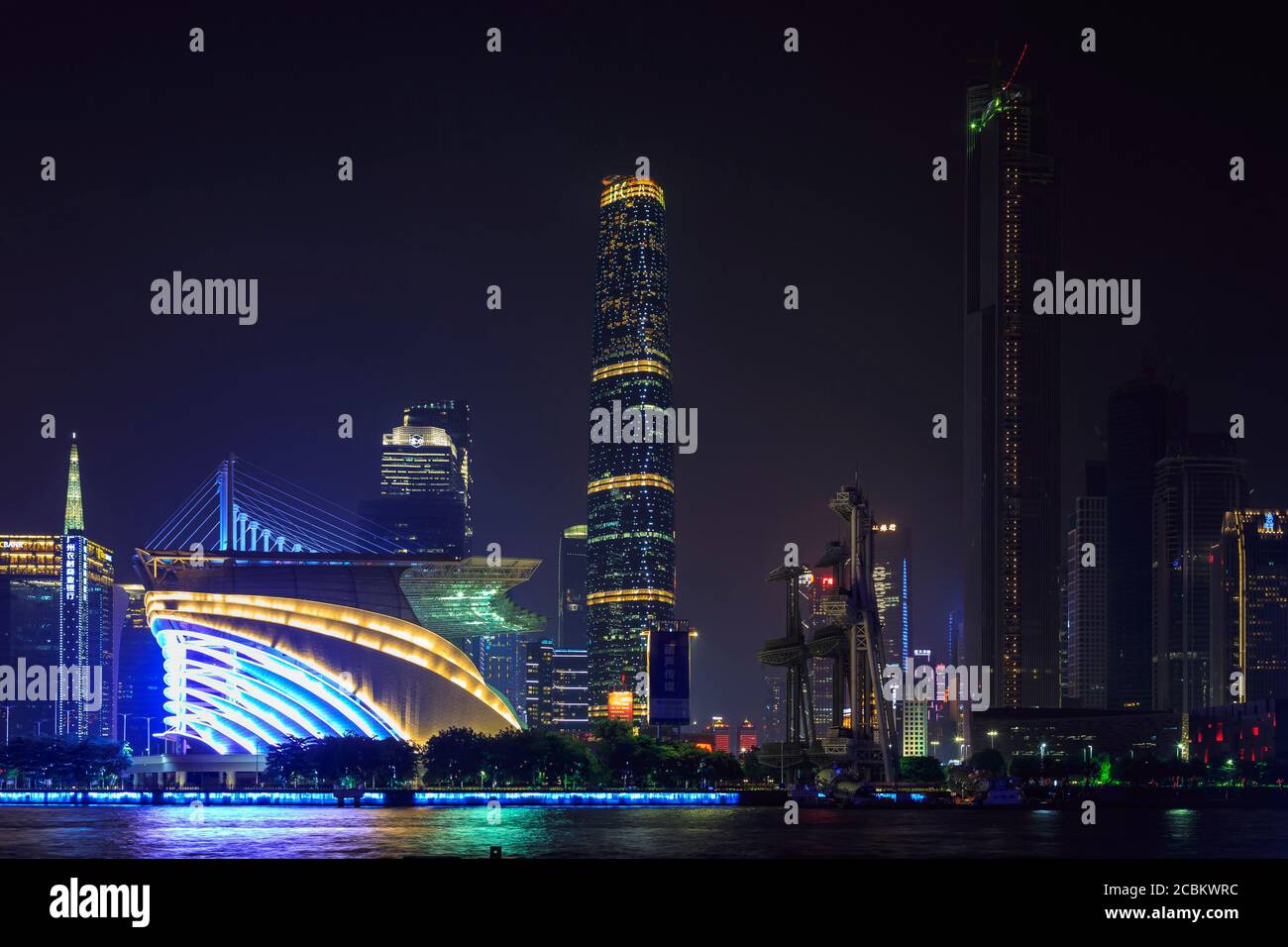 Skyscrapers and Riverfront olympic stadium illuminated at night, Guangzhou, China Stock Photo