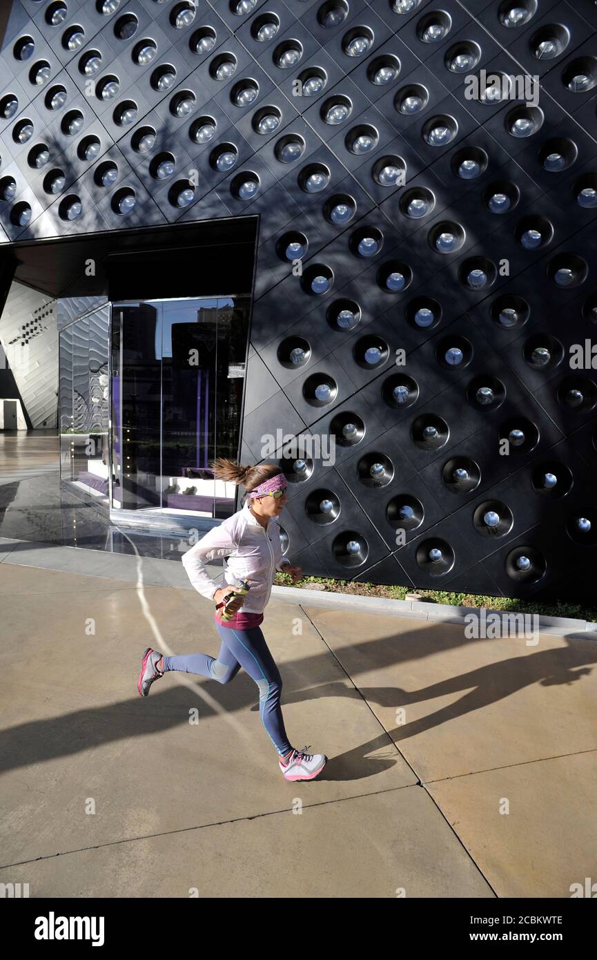 Mid adult female runner running on las Vegas Strip, Las Vegas, Nevada, USA Stock Photo