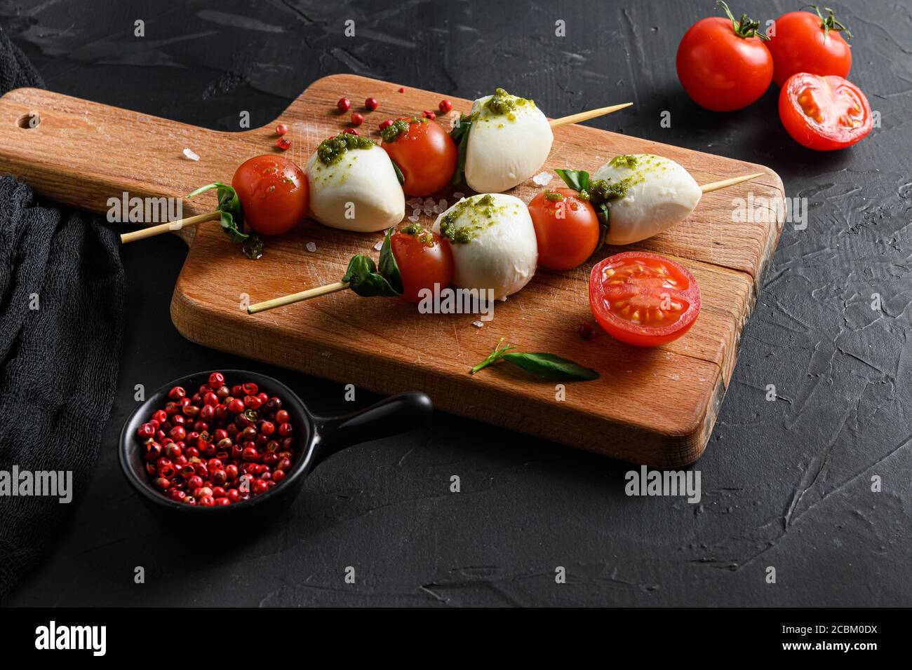 Caprese salad Tomato and mozzarella slices with basil leaves on sticks ...