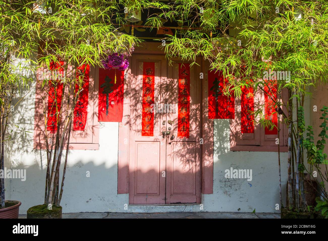 Building with pink and red window shutters, Malacca, Malaysia Stock