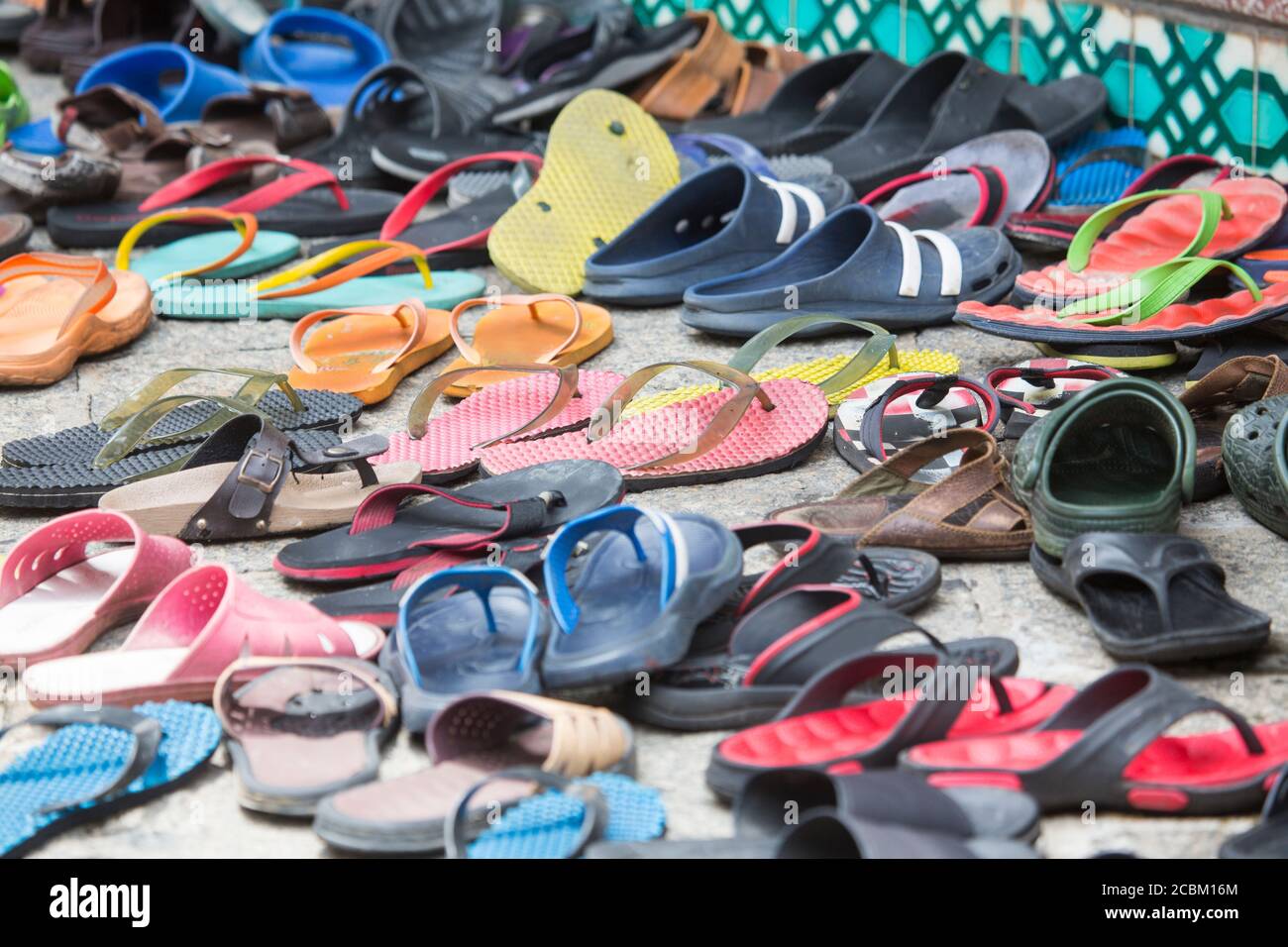Rows of footwear and flip flops on sidewalk outside Mosque, Malacca, Malaysia Stock Photo Alamy