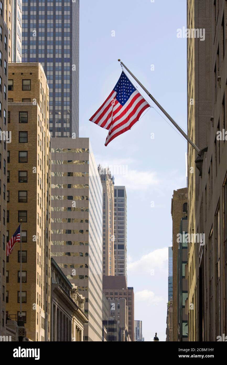 Skyscrapers with stars and stripes flag flying, New York City, New York, USA Stock Photo