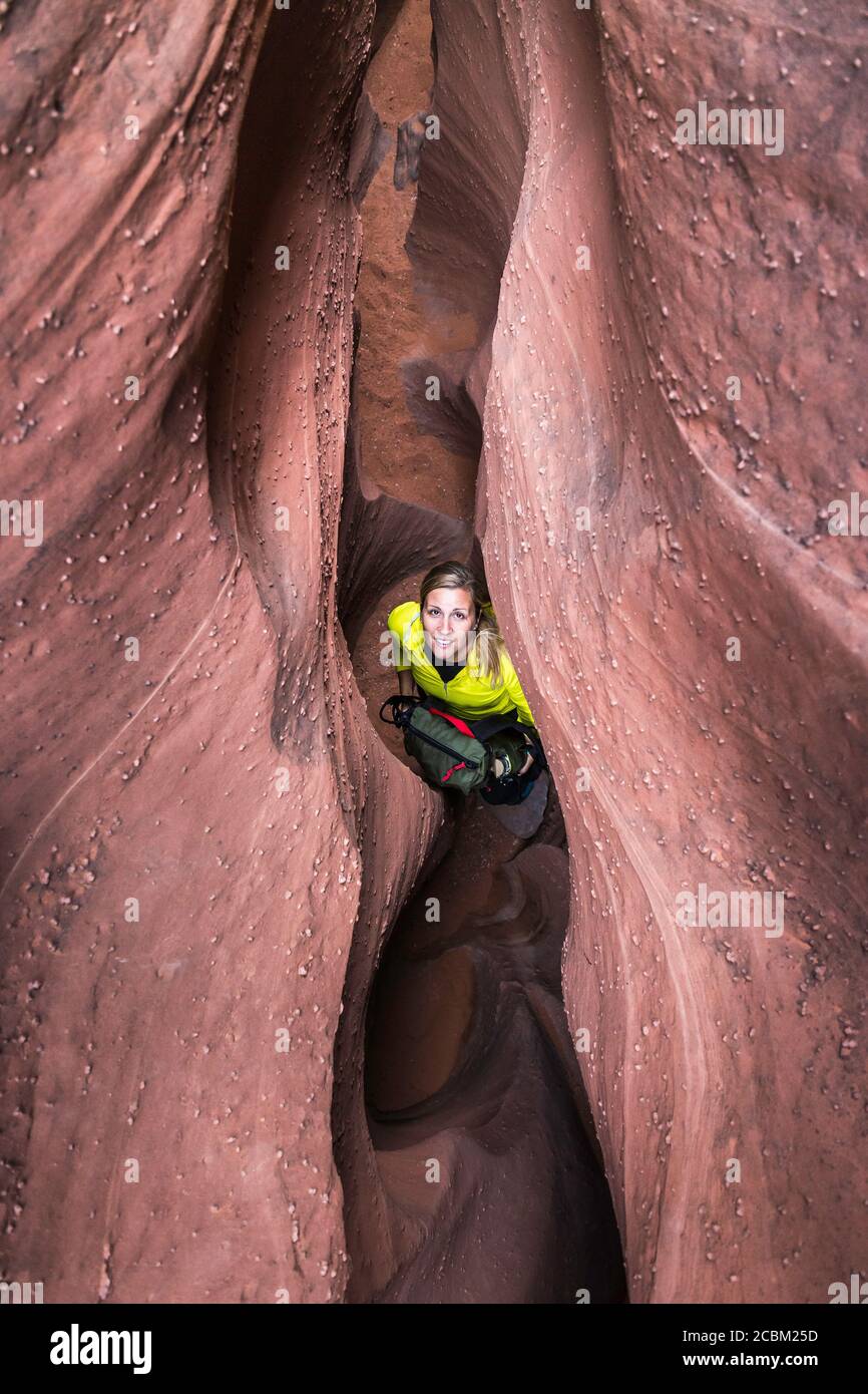 Woman exploring slot canyon Grand Staircase-Escalante National Monument, Utah, USA Stock Photo