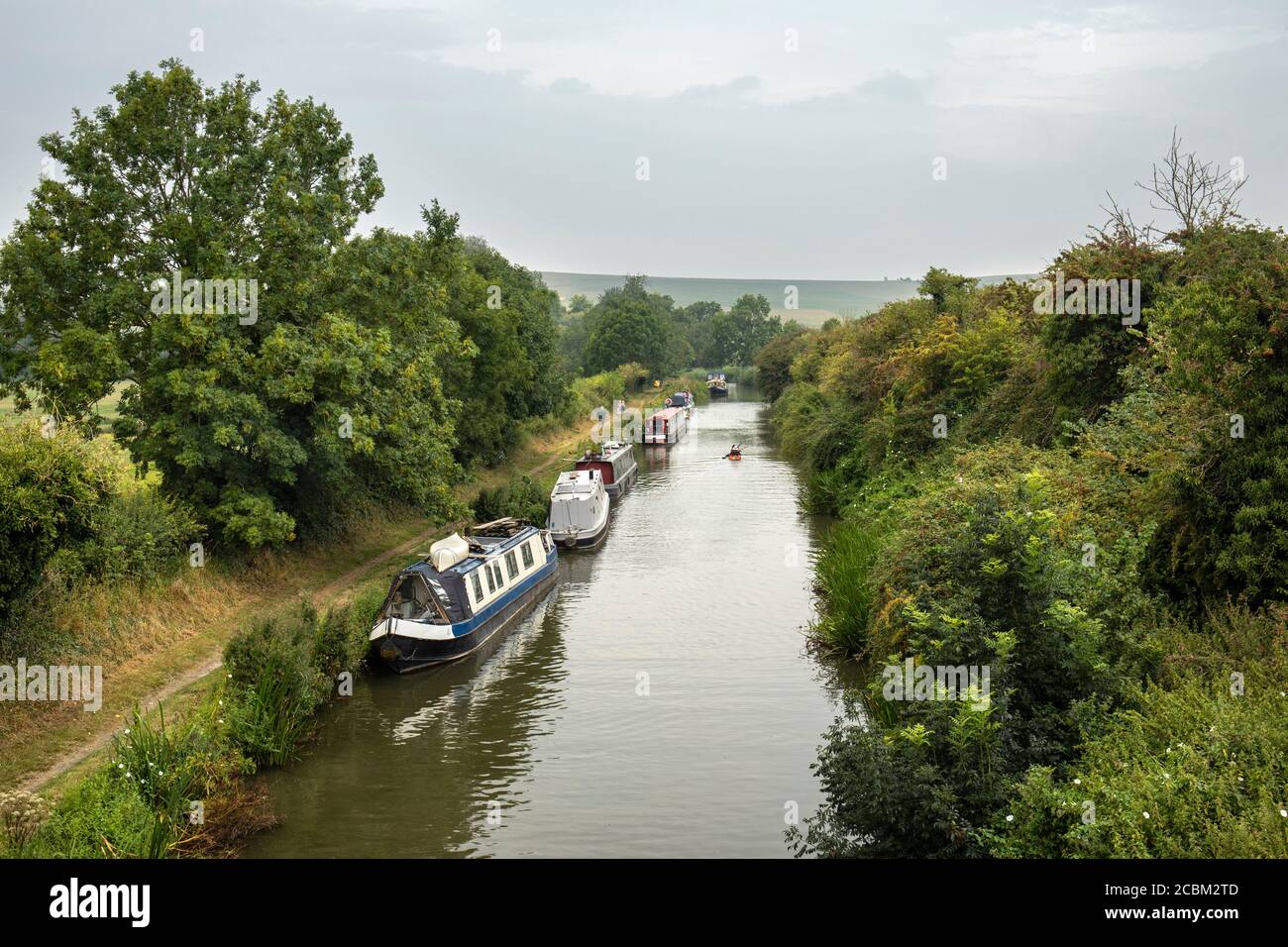 Canal boats moored beside the towpath of The Kennet and Avon Canal near Stanton St Bernard, The Vale of Pewsey, Wiltshire, England, UK Stock Photo